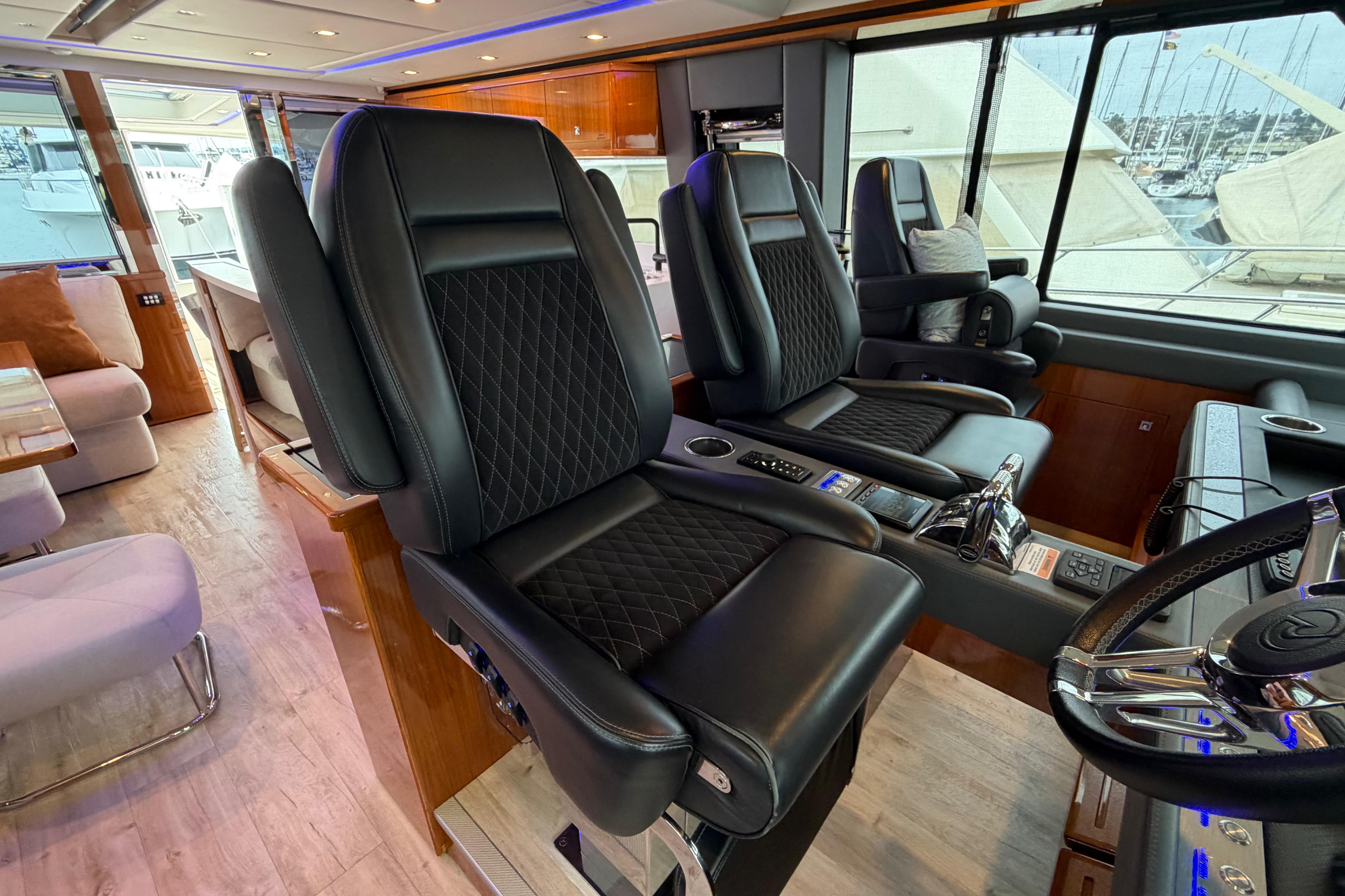 Luxurious interior of 2023 Riviera 645 SUV yacht with leather seating and modern controls.