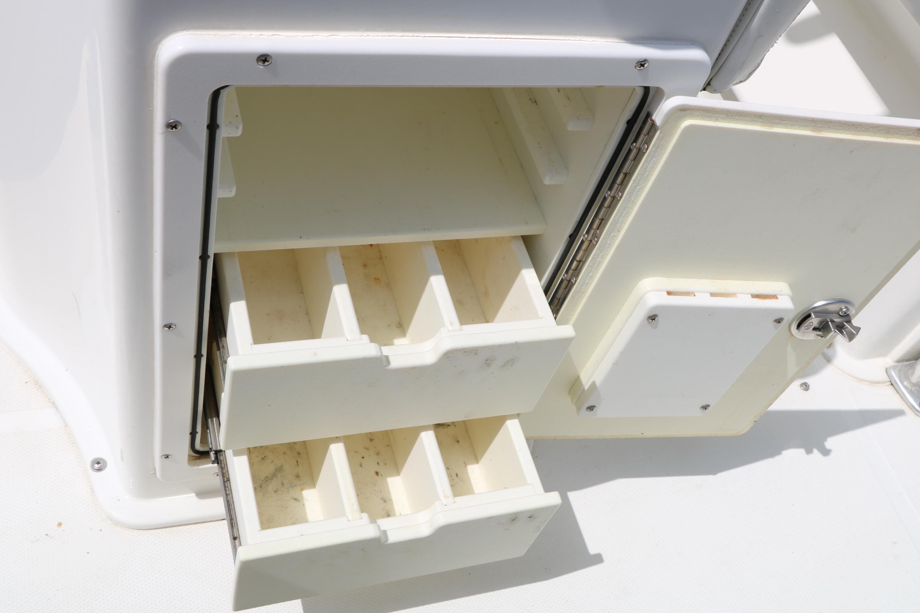Storage compartments on a 2015 Sea Hunt BX 22 BR boat, featuring open drawers.