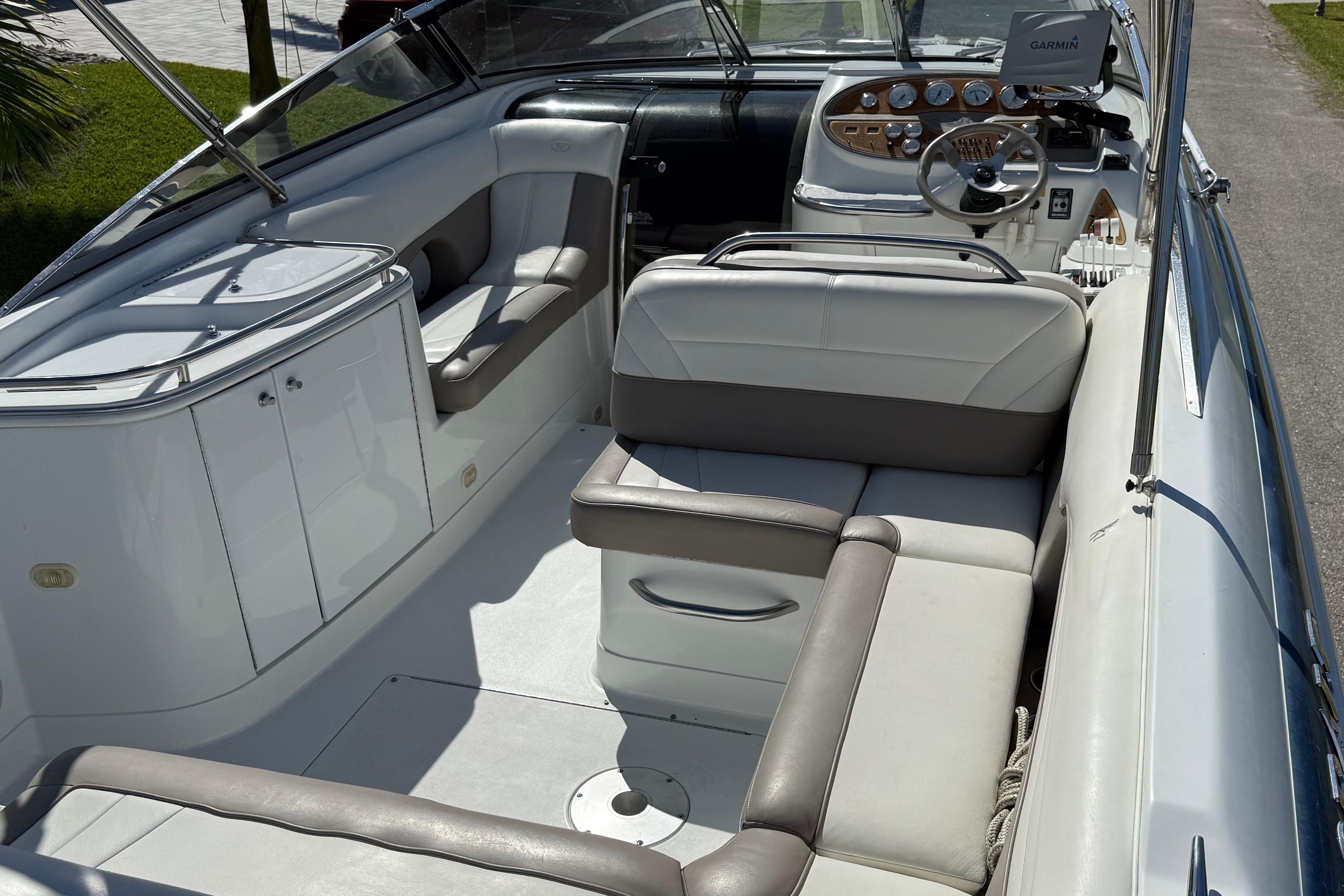 1999 Cobalt 293 boat interior with white and gray seating, steering wheel, and control panel.