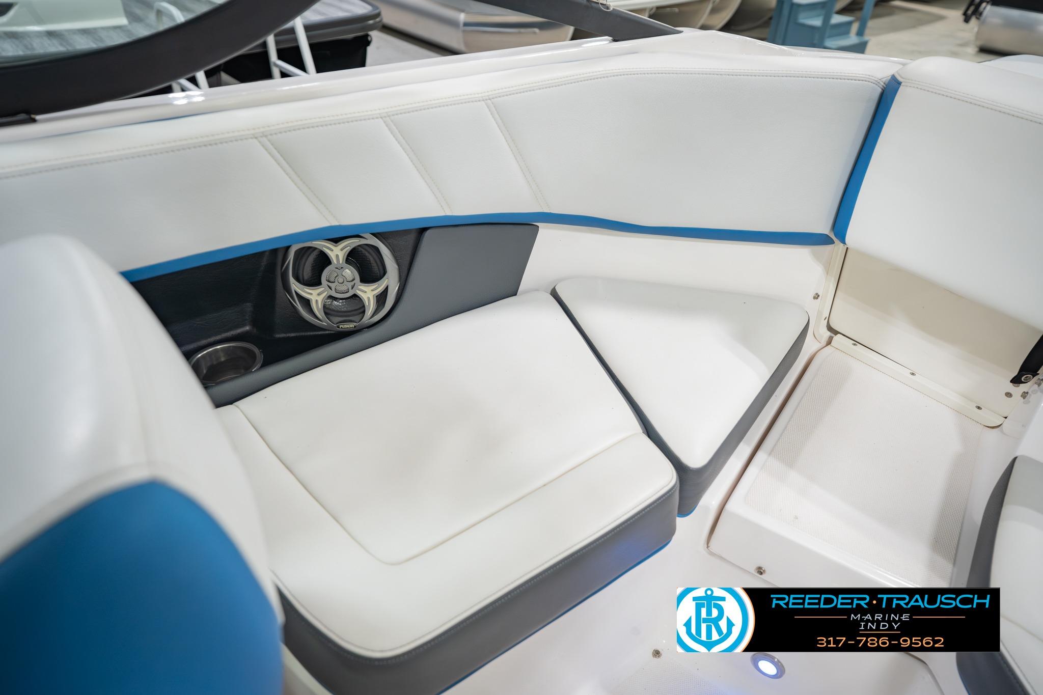 2015 Regal 2000 ESX Bowrider interior with white and blue seating, speaker, and cup holder.