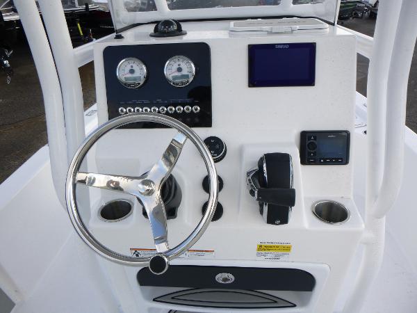 2025 Sea Pro 230 Bay boat console with steering wheel, gauges, and electronic controls.