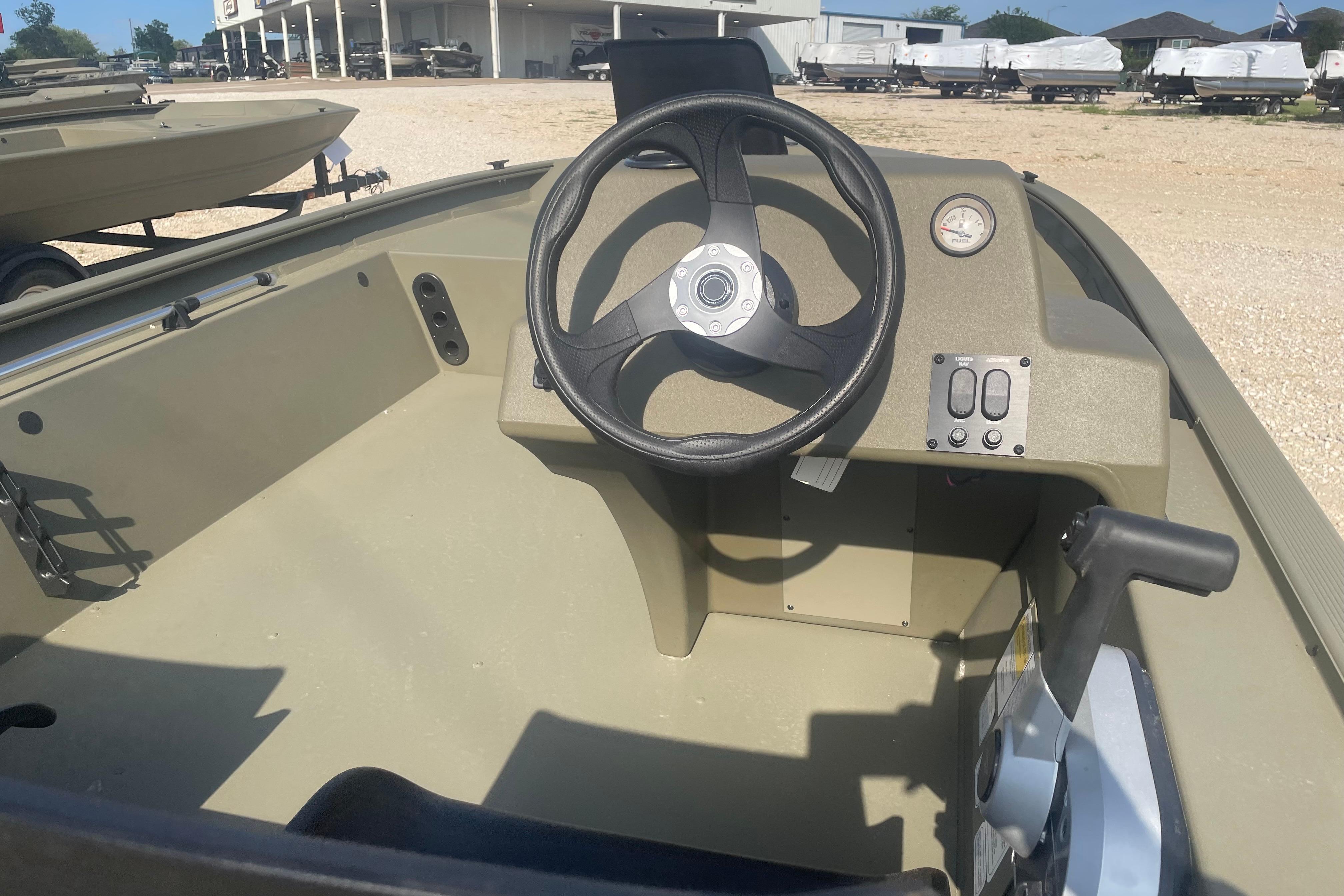2026 Tracker Grizzly 1754 SC boat interior with steering wheel and control panel.