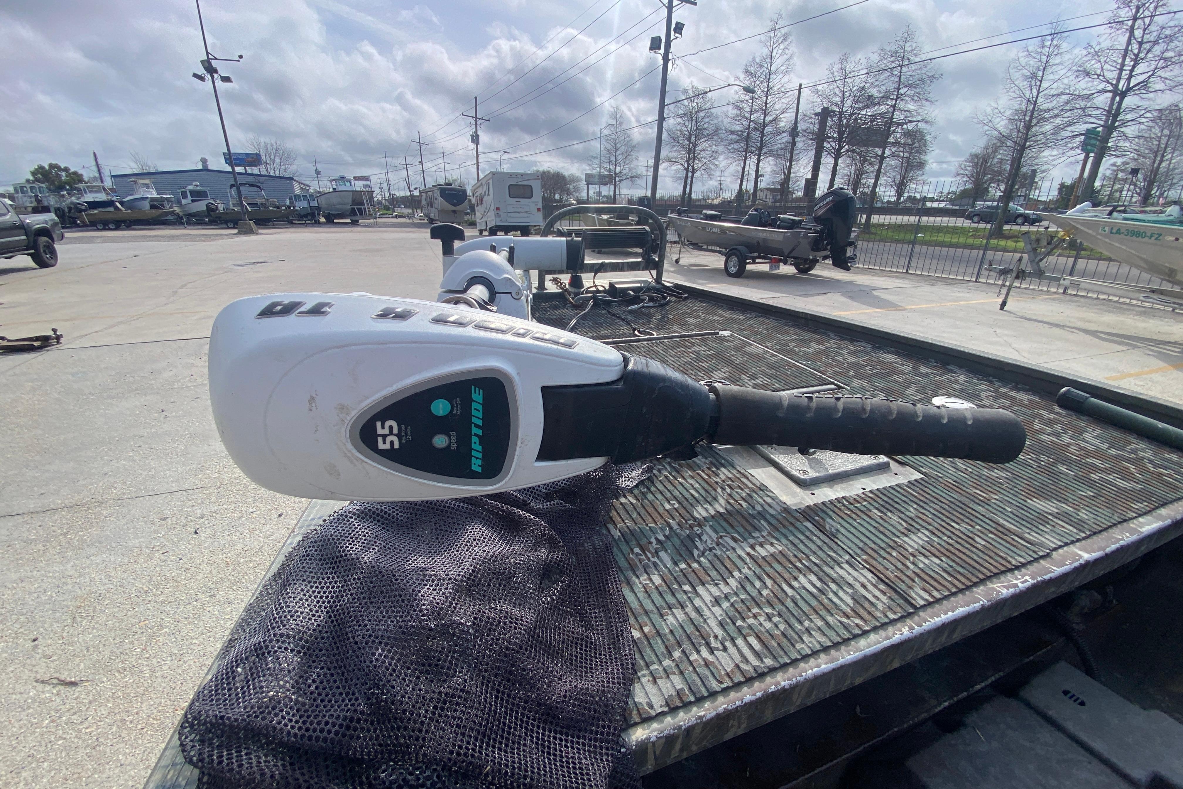 2009 Gator Trax MUD BUDDY boat with Riptide trolling motor in a parking lot.