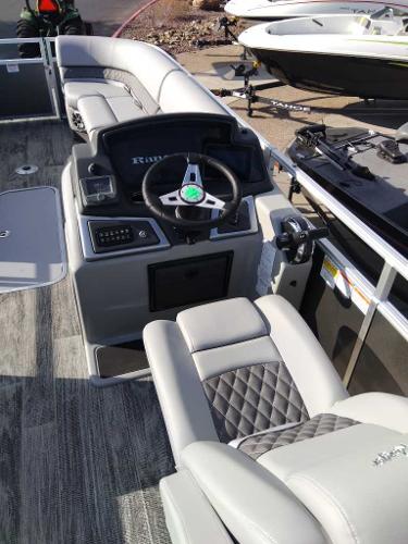 2024 Ranger Reata 223C boat interior with modern steering console and plush seating.