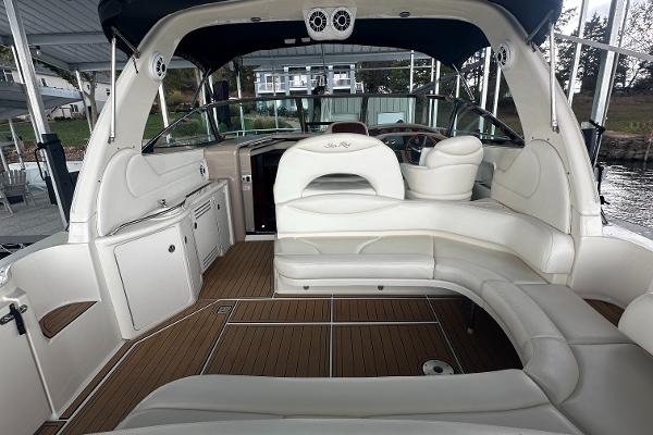 2004 Sea Ray 380 Sundancer interior with white seating and wood flooring.