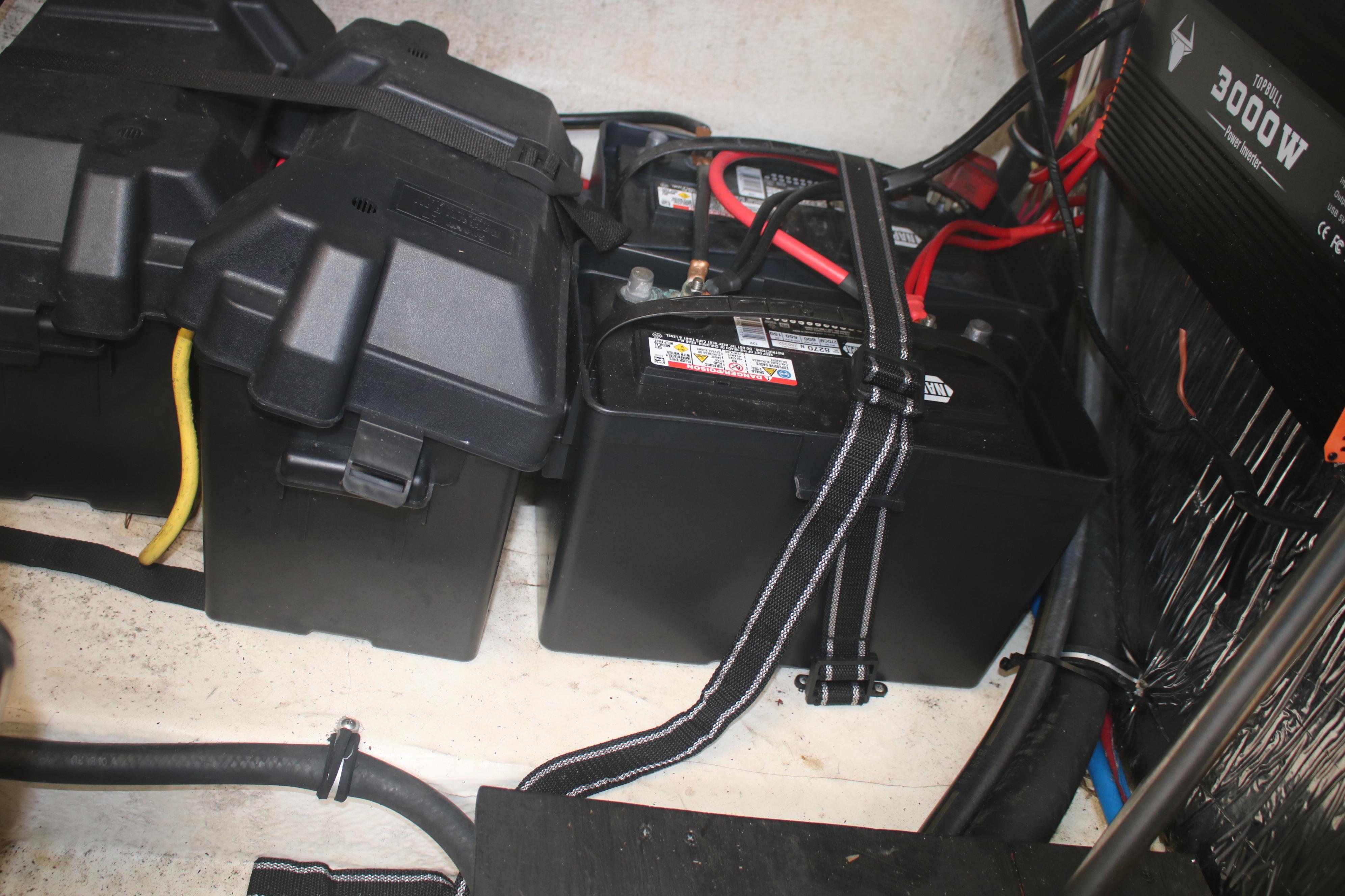 Battery compartment of a 2011 Larson Carbiro 240 boat with power inverter.