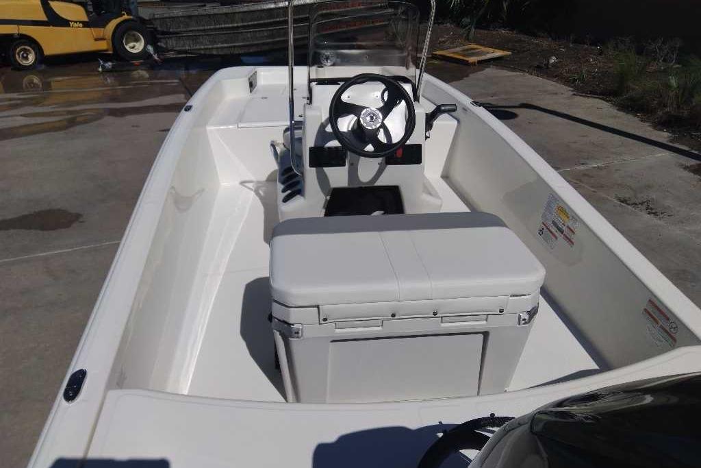 2026 Mako Pro Skiff 15 CC boat interior with steering wheel and seating.