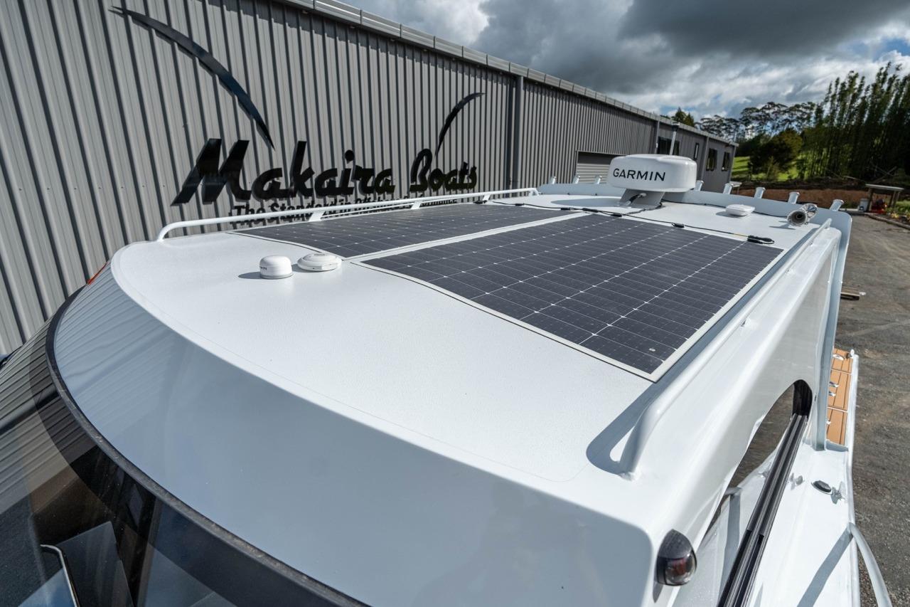2025 Makaira Gen 3 36 boat with solar panels and Garmin equipment, docked near Makaira Boats building.