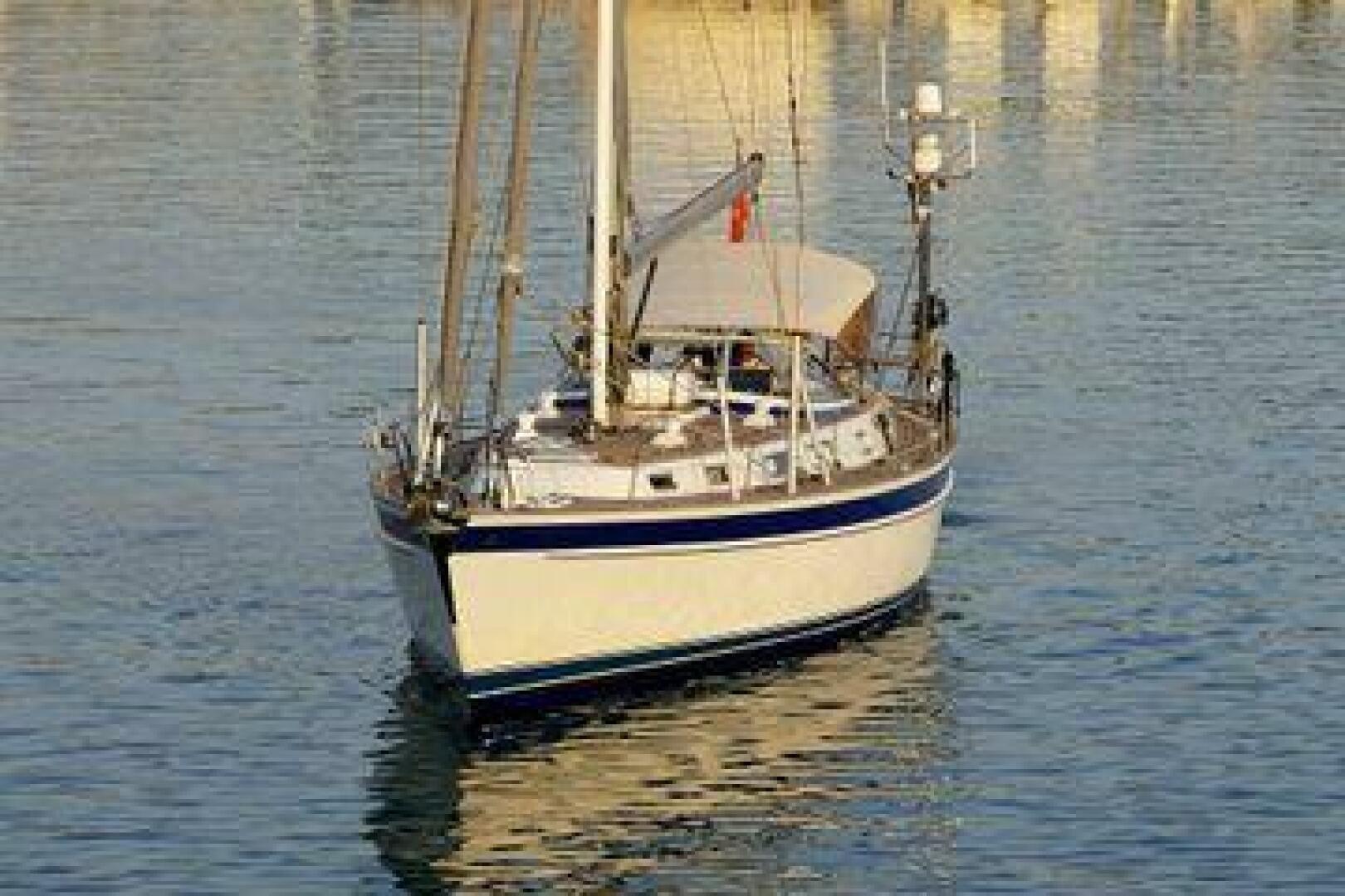 2002 Hallberg-Rassy 53 sailboat on calm water, front view.
