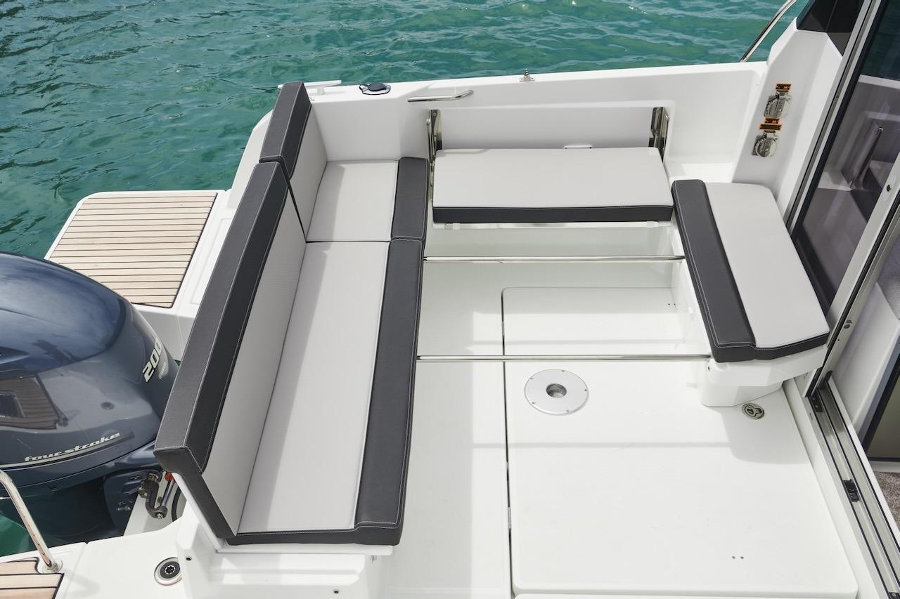 2025 Jeanneau NC 795 Series 2 boat deck with seating, near water.