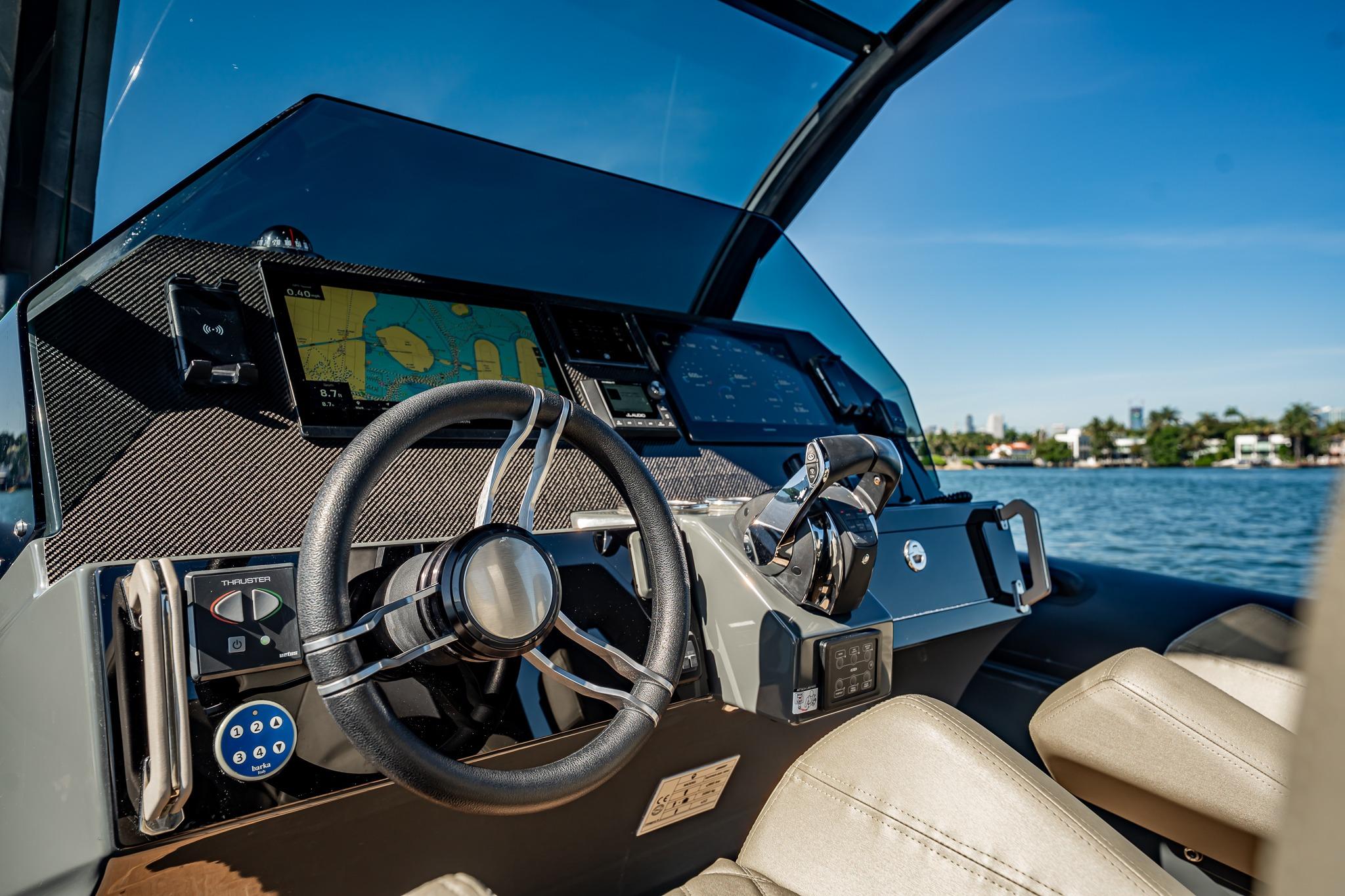 Cockpit of 2023 Skipper-BSK 38NC boat with modern navigation system and steering wheel.