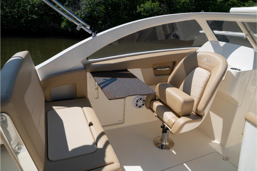 2023 Scout 240 Dorado boat interior with beige seating and table.