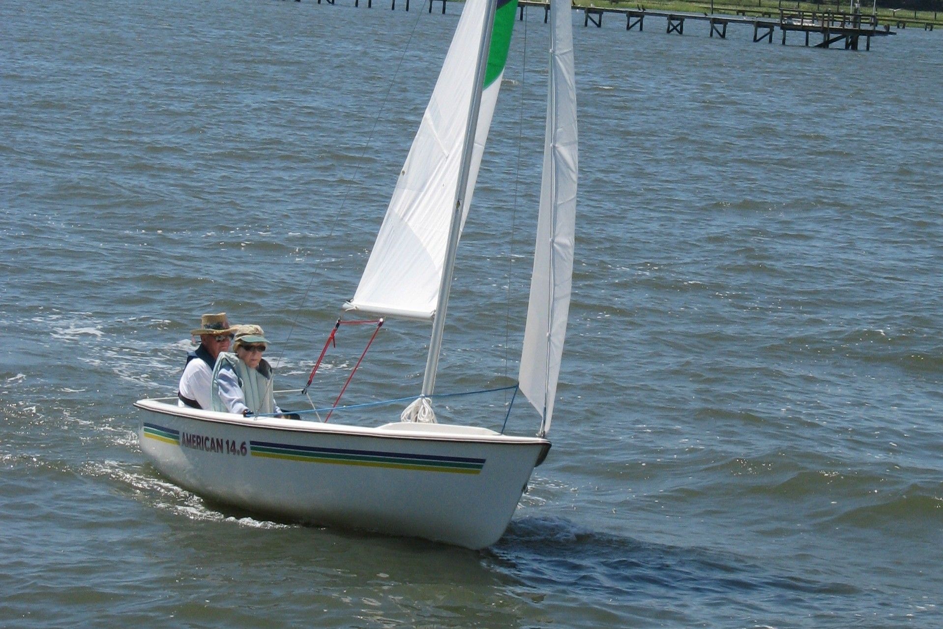 Two people sailing on an American Sail AMERICAN 14.6 boat.