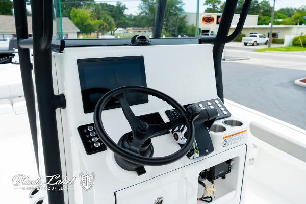 2025 Caymas 281 HB boat dashboard with steering wheel and electronic controls.