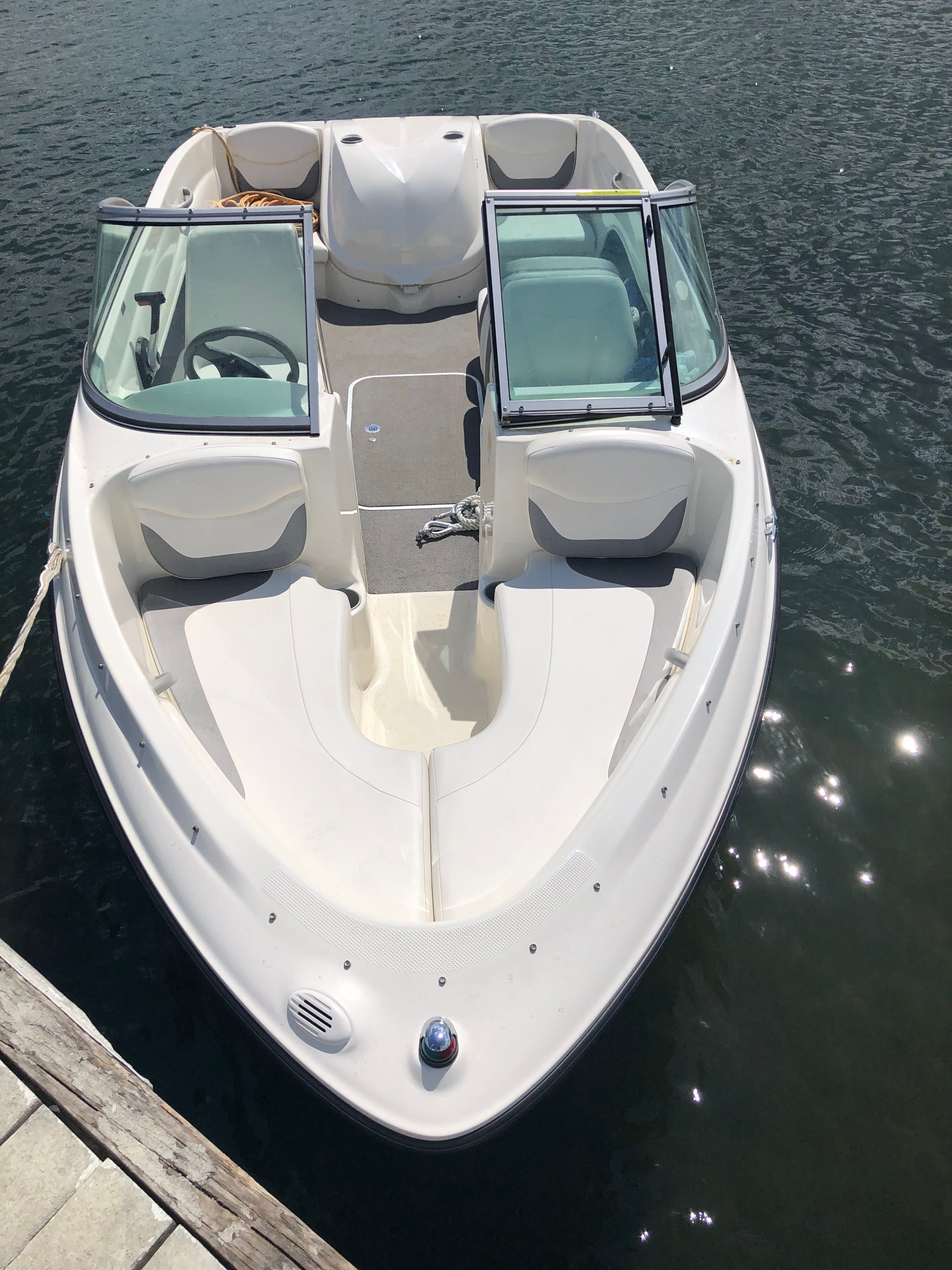 A white Bayliner 175 Bowrider boat docked on the water.