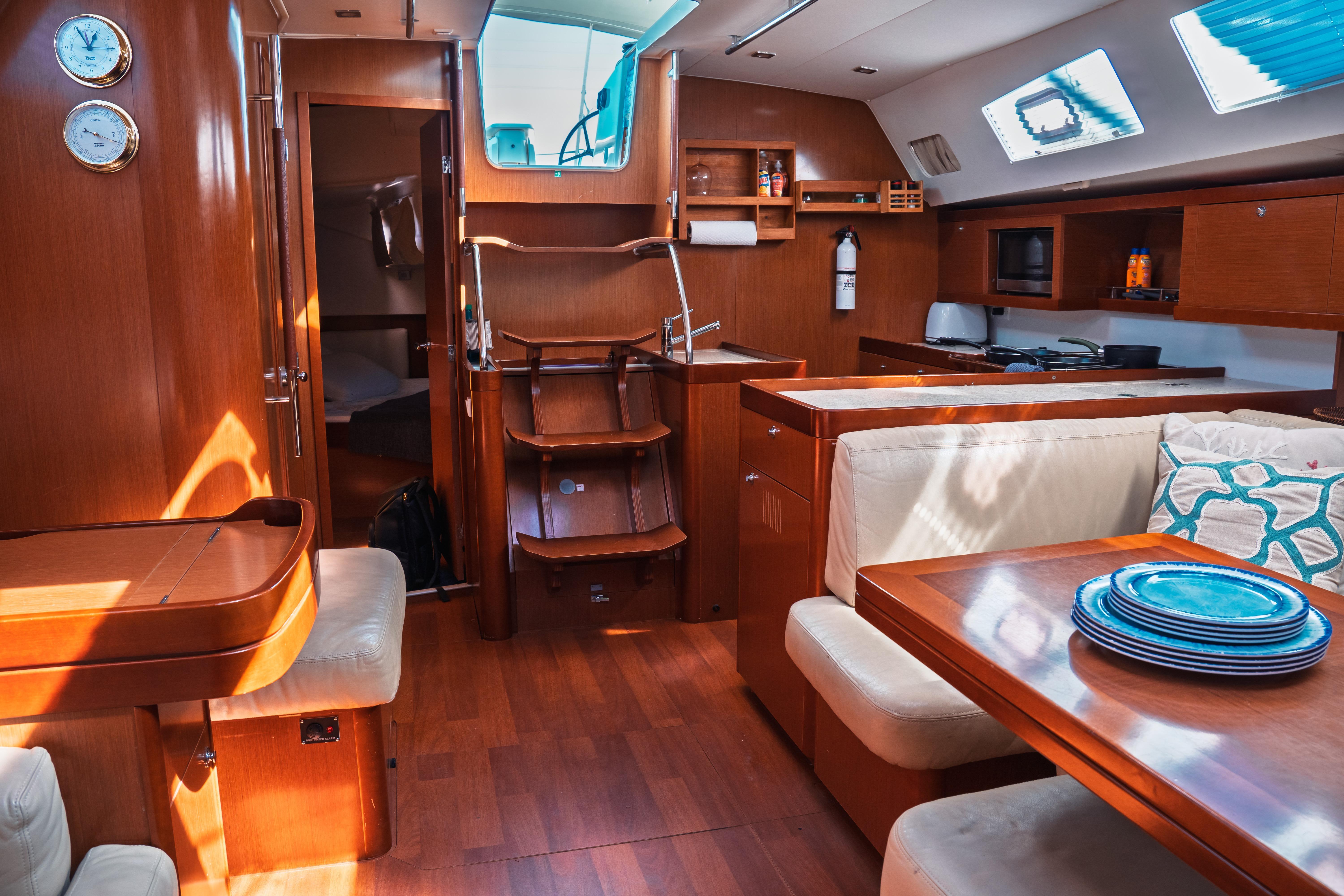 Luxurious interior of 2011 Beneteau Oceanis 50 yacht with wood finish and modern amenities.
