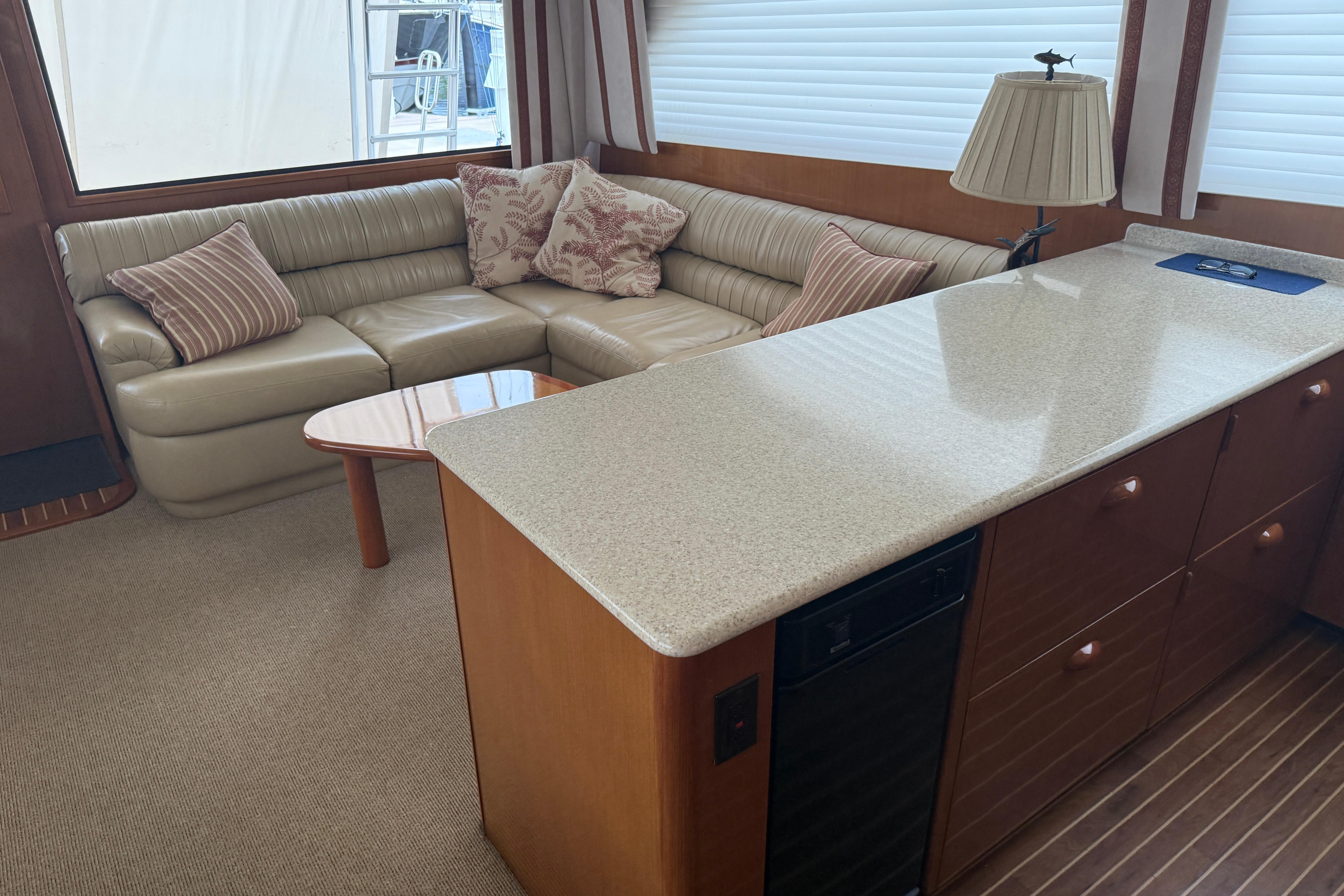 Interior of a 2000 Viking 55 Convertible yacht with a cozy seating area and elegant decor.