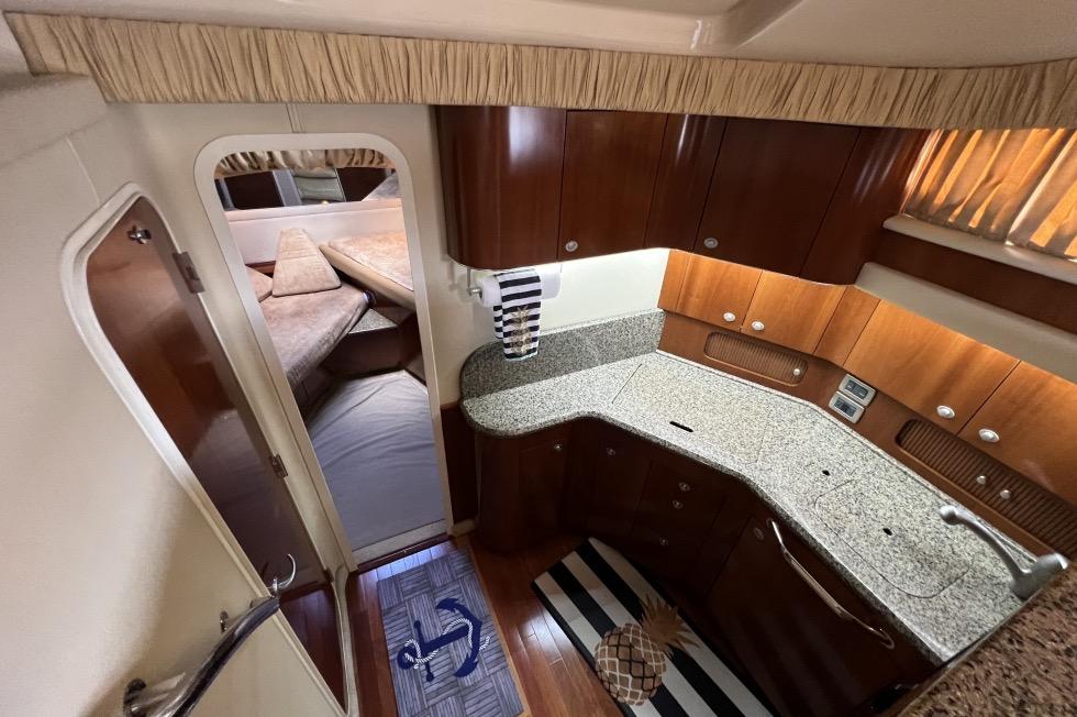 2005 Sea Ray 390 Motor Yacht interior with modern kitchen and cozy cabin.