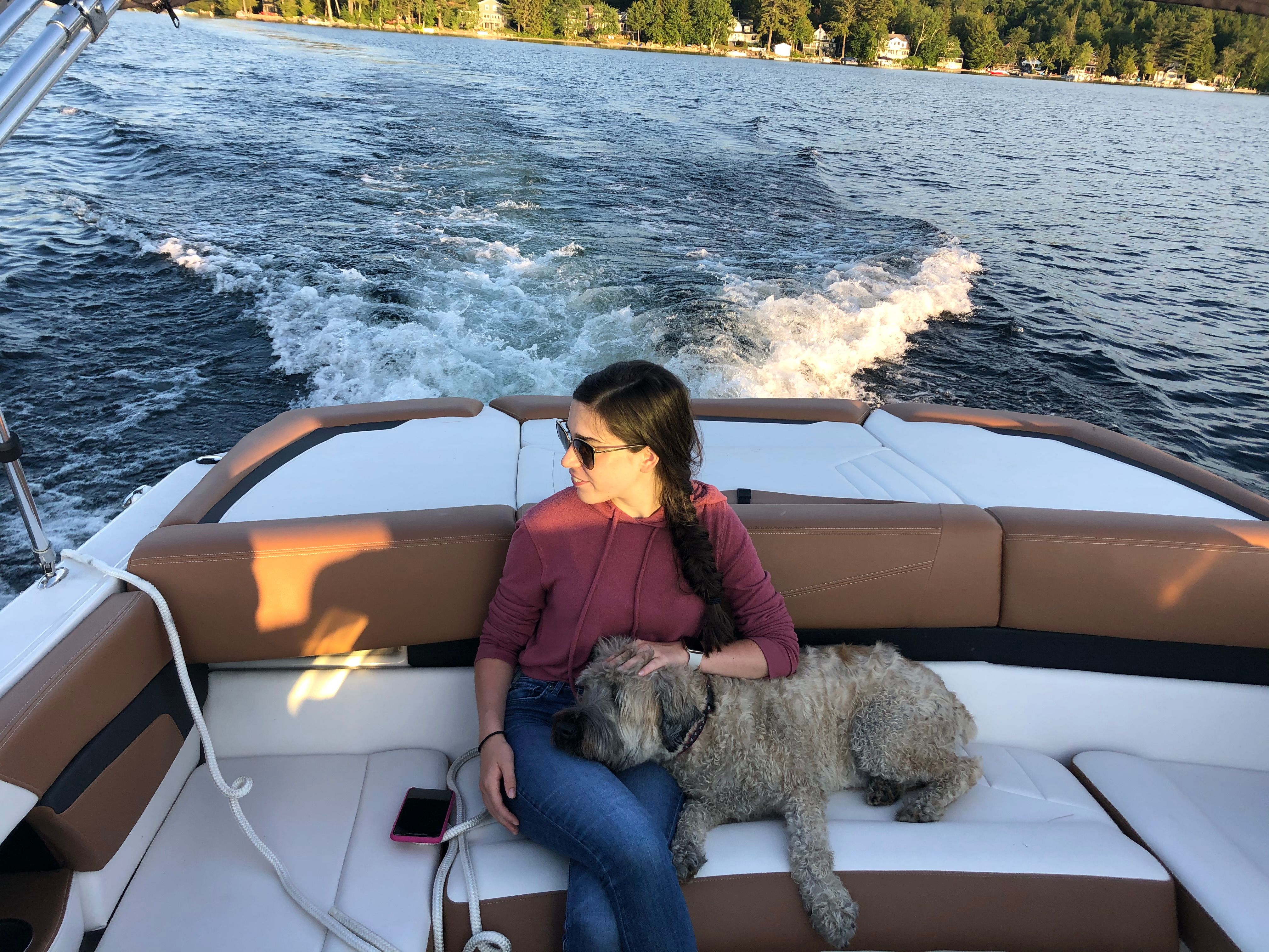 Woman with dog on 2017 Four Winns H230 boat.