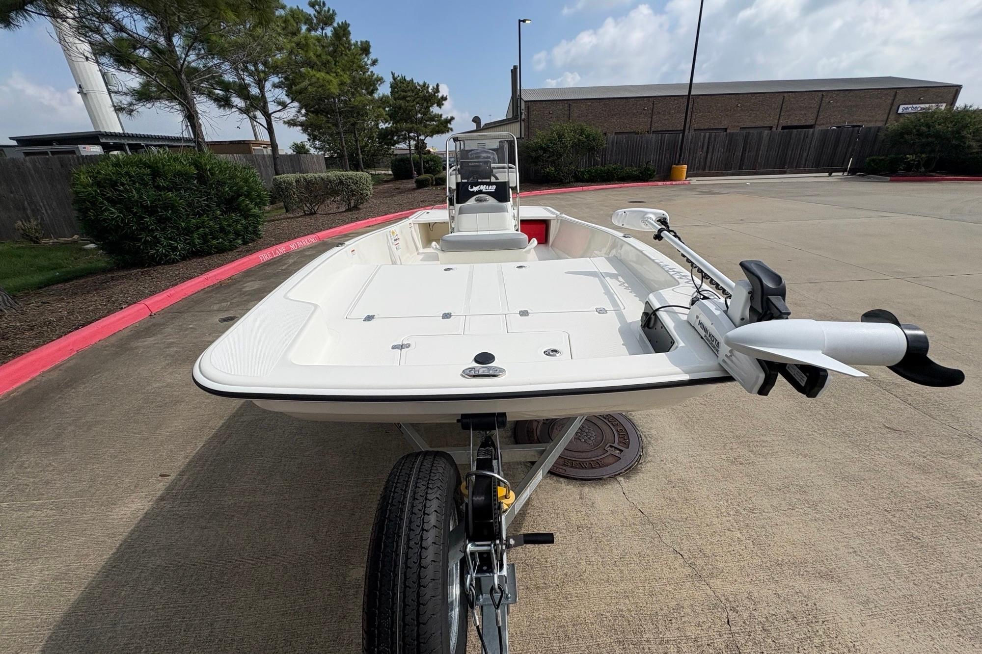 2026 Mako Pro Skiff 15 CC boat on trailer, parked outdoors.
