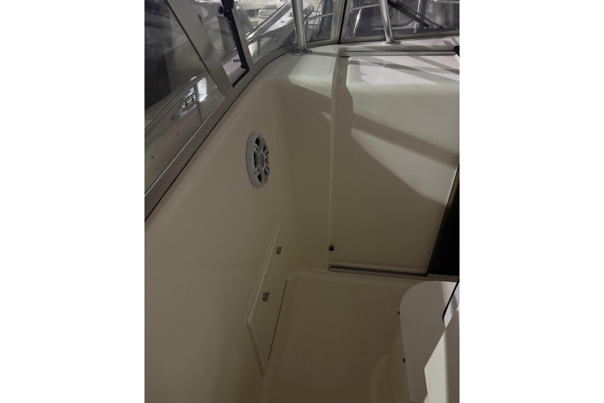 2000 Pursuit 3070 Offshore Center Console interior with speaker and storage compartment.