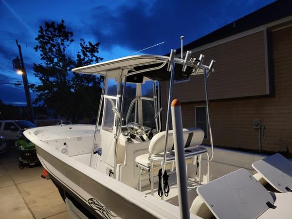 2011 Carolina Skiff 258 DLV boat at dusk, parked in driveway.