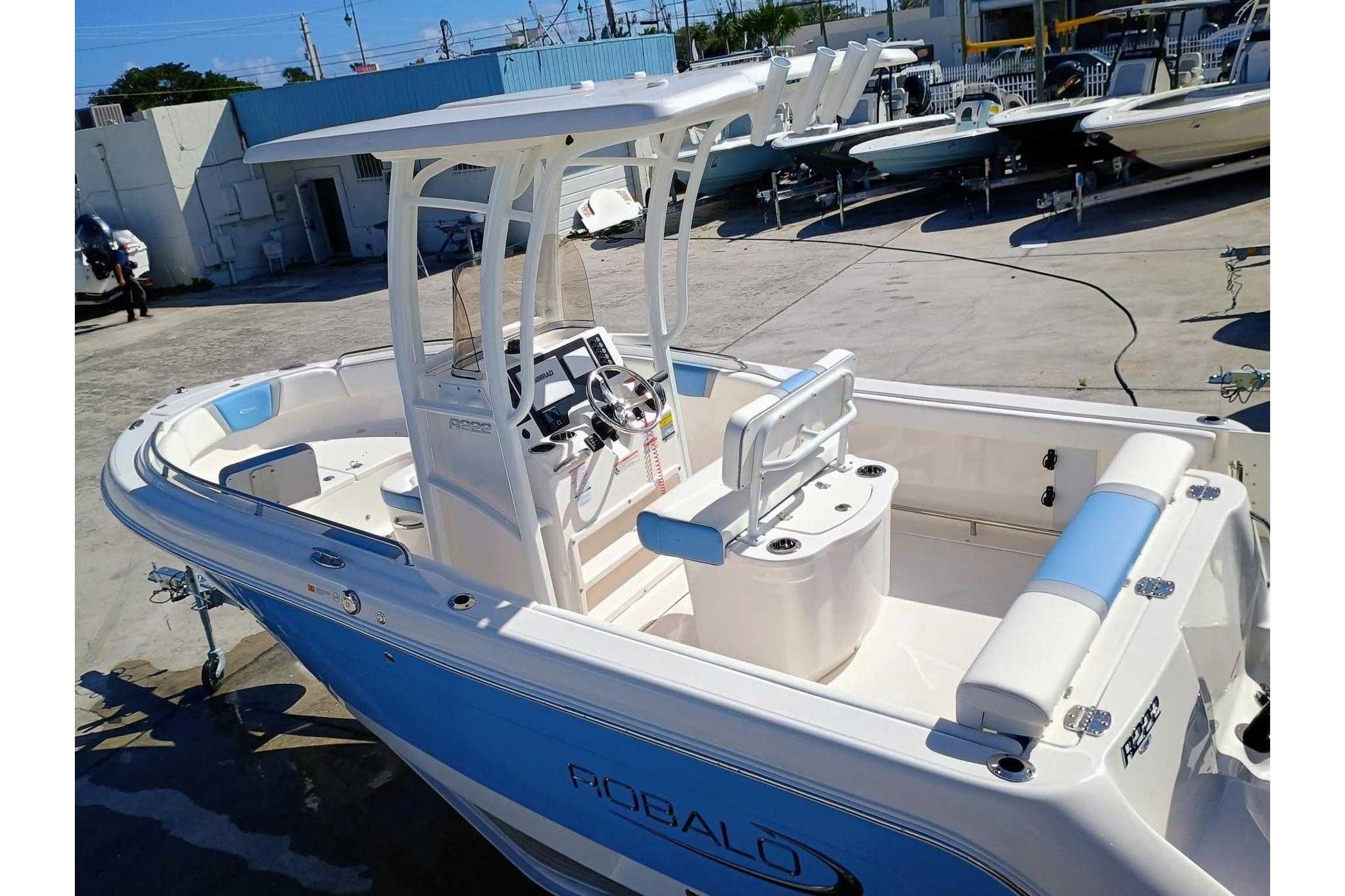 2025 Robalo R222 Center Console boat with blue accents, docked outdoors.