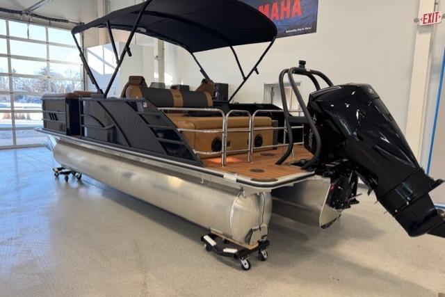 2026 Bentley Pontoons Elite 223 Swingback in showroom, featuring sleek design and powerful outboard motor.