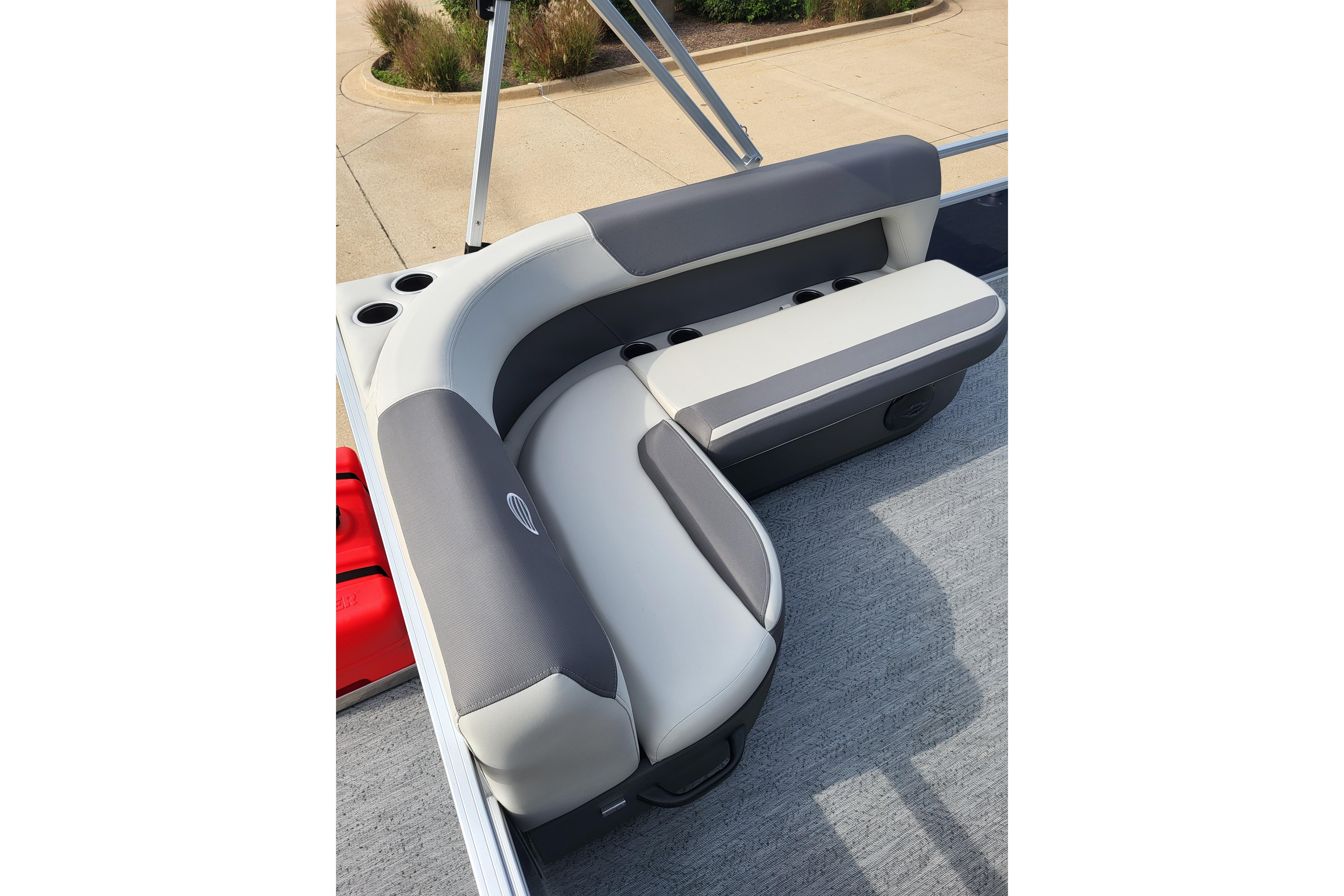 2026 Sun Tracker Bass Buggy 16 XL Select boat seating with cup holders, featuring gray and white upholstery.
