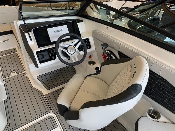 Interior of 2025 Sea Ray SPX 230 boat, featuring modern steering and seating.