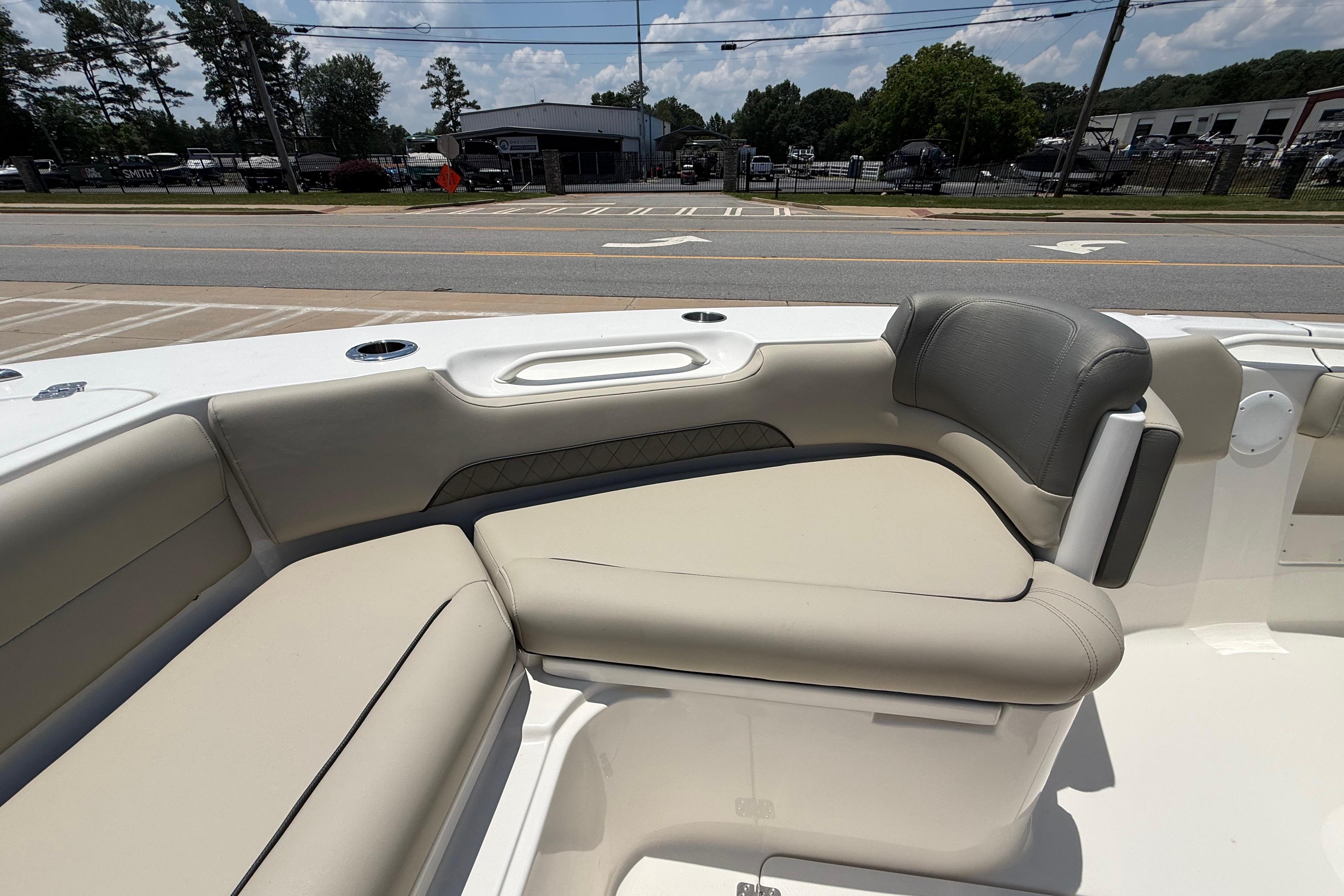 2027 Key West 249 FS boat interior with beige seating and cup holders.