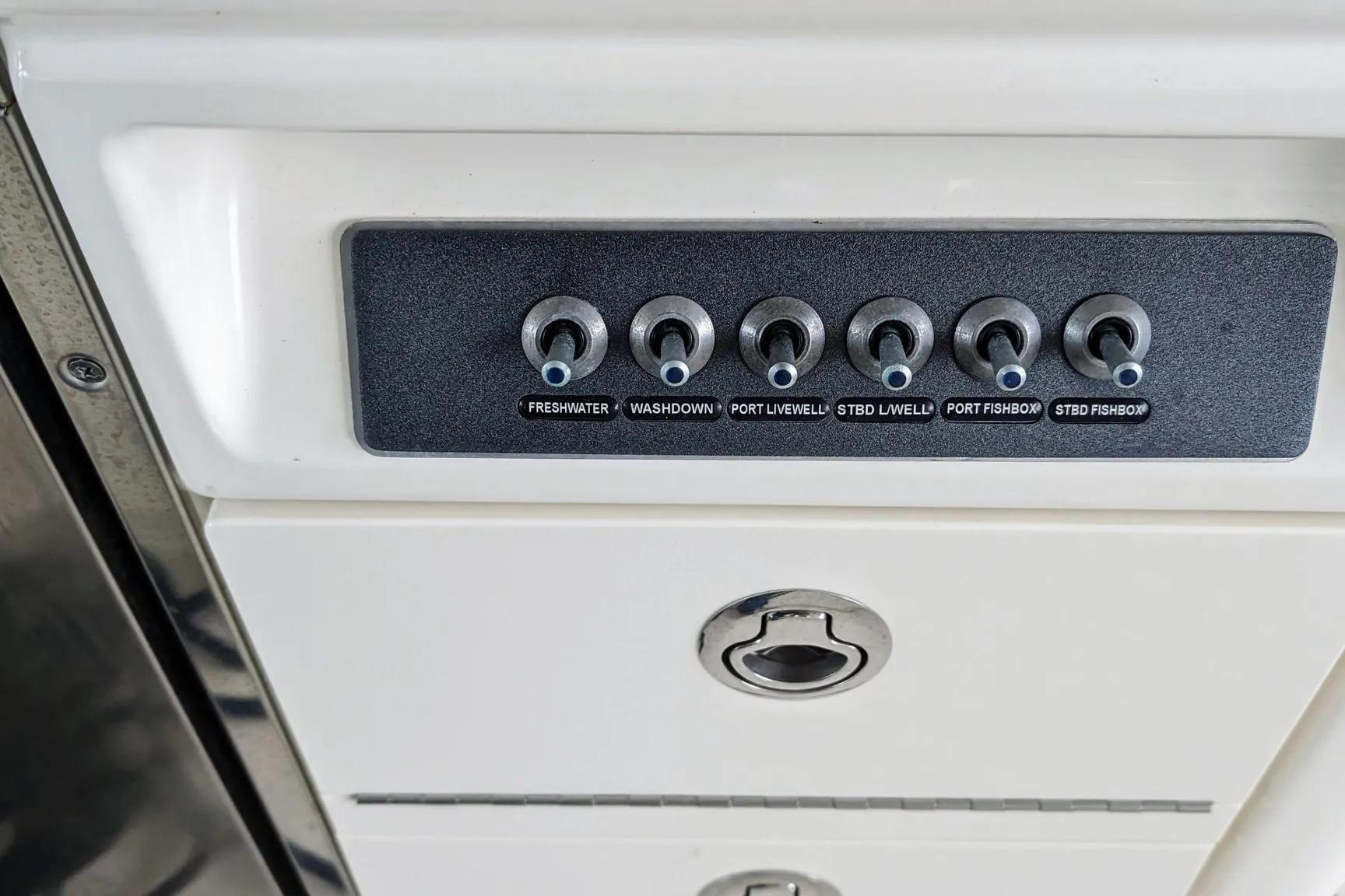 Control panel on a 2017 Boston Whaler 320 Vantage boat, featuring various switches.