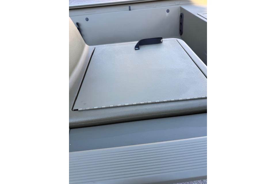 2026 Tracker Grizzly 1754 SC boat storage compartment with a closed lid and handle.