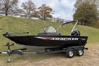 2026 Tracker Pro Guide V-175 WT boat on trailer, parked on grassy area.