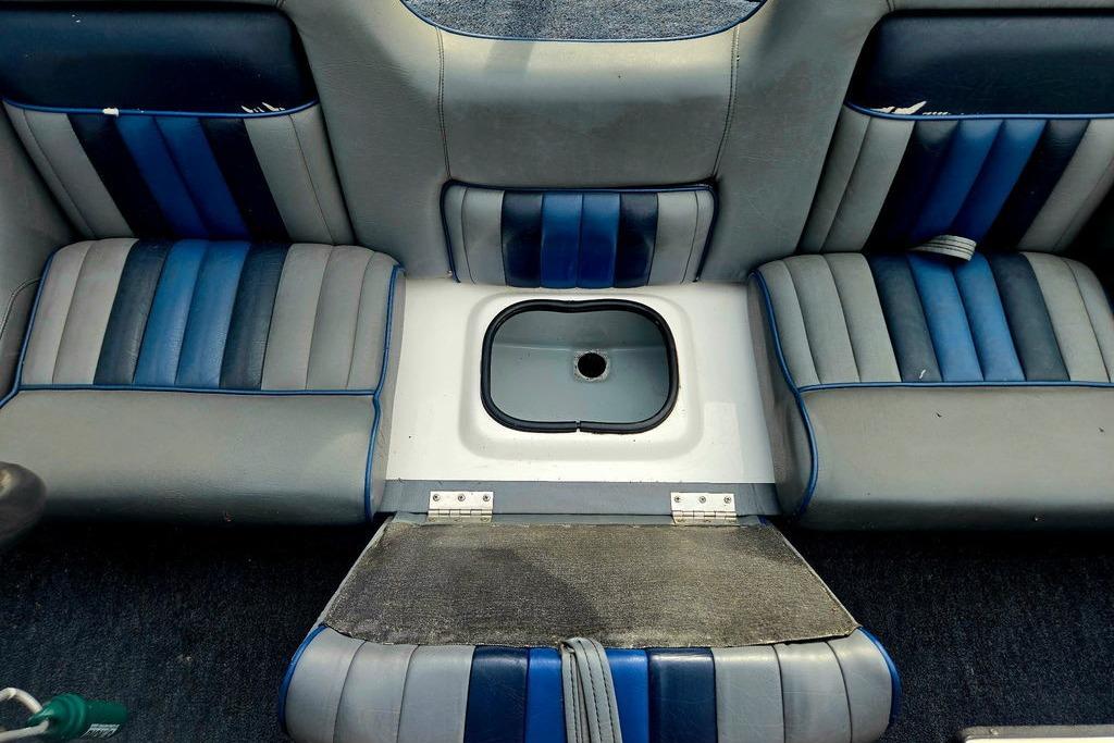 Interior seating of a 1996 Champion 181 SX boat with blue and gray upholstery.