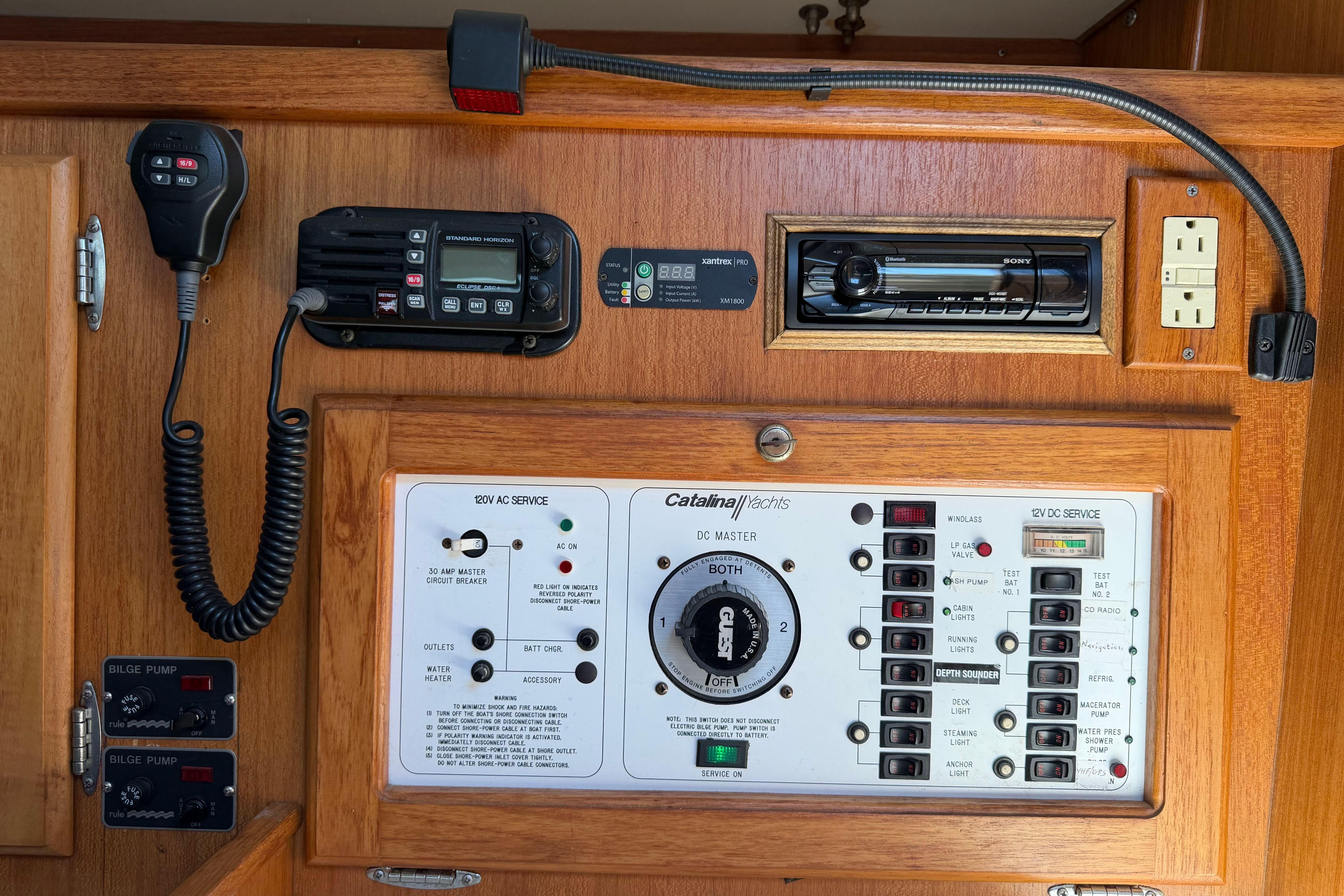 Control panel of a 1995 Catalina 36 MkII yacht with communication and electrical systems.