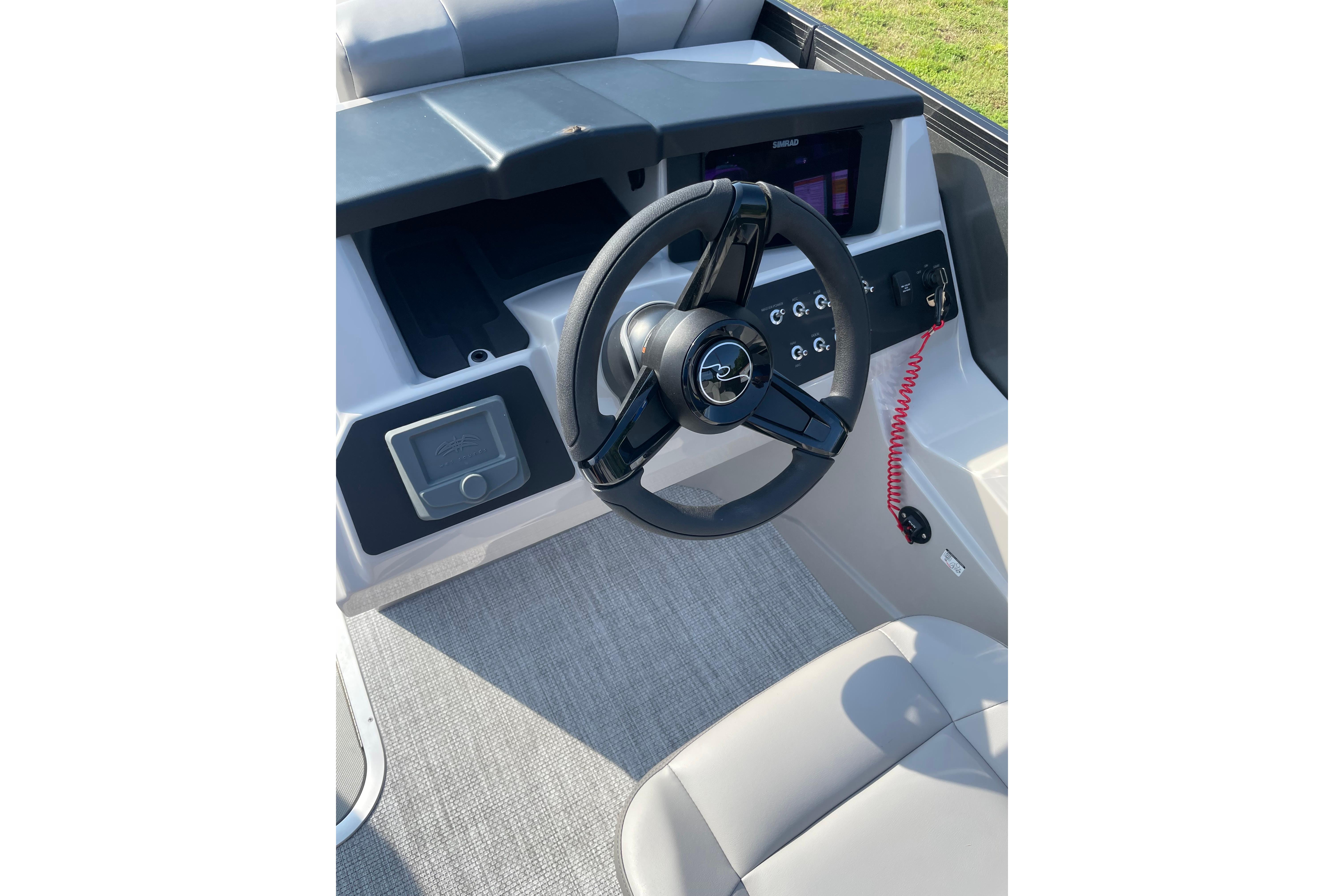 Steering console of 2027 Alera a24 boat with modern controls and sleek design.