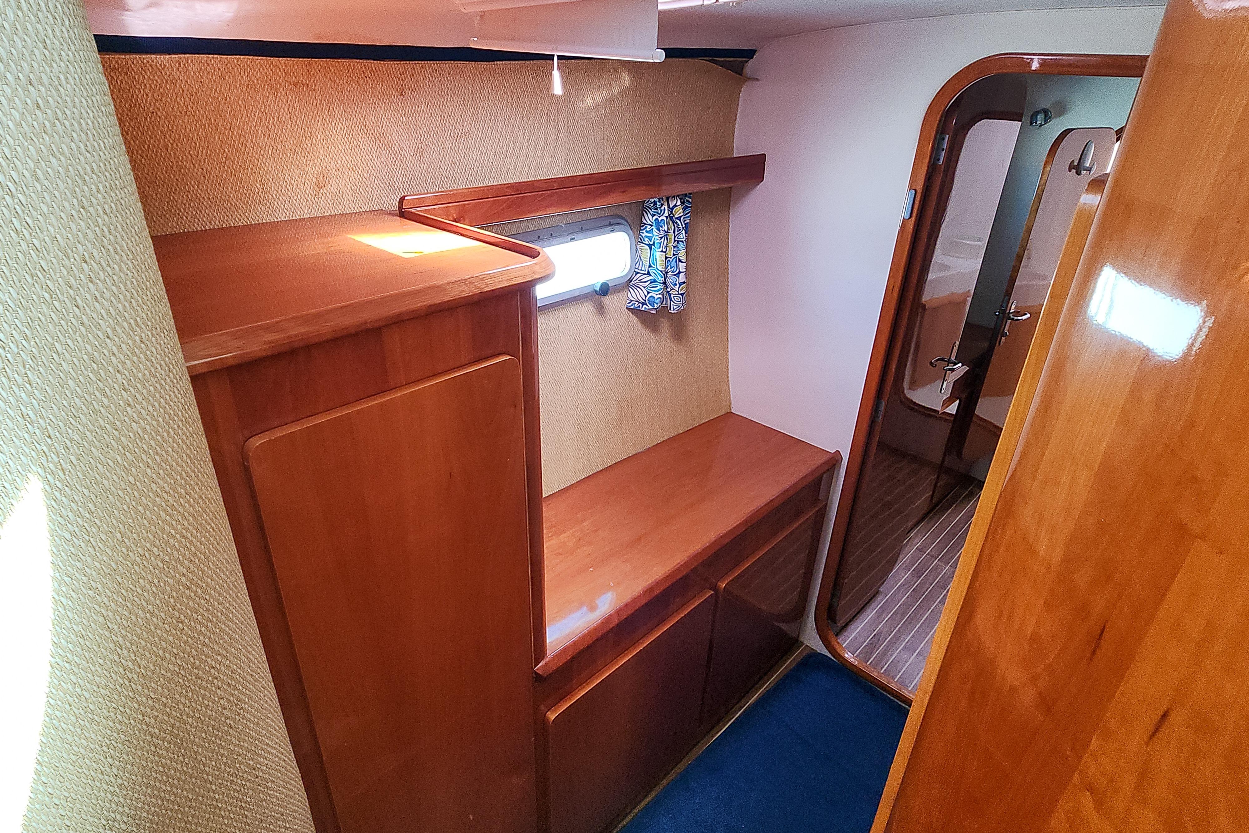Interior of 2001 Privilege 435 yacht with wooden cabinetry and nautical decor.