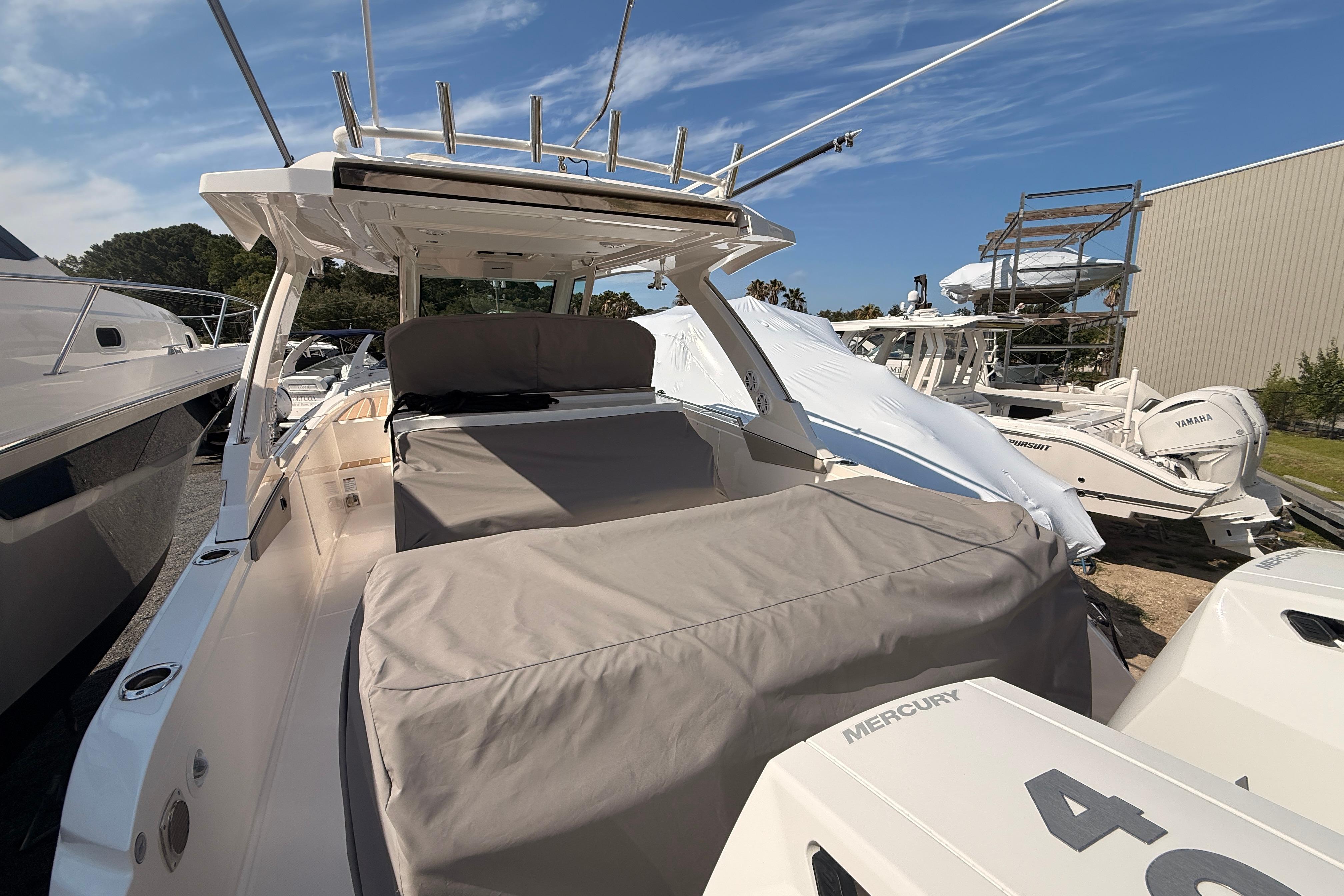 2024 Tiara Yachts 34 LS boat with covered seating and Mercury engines, docked outdoors.