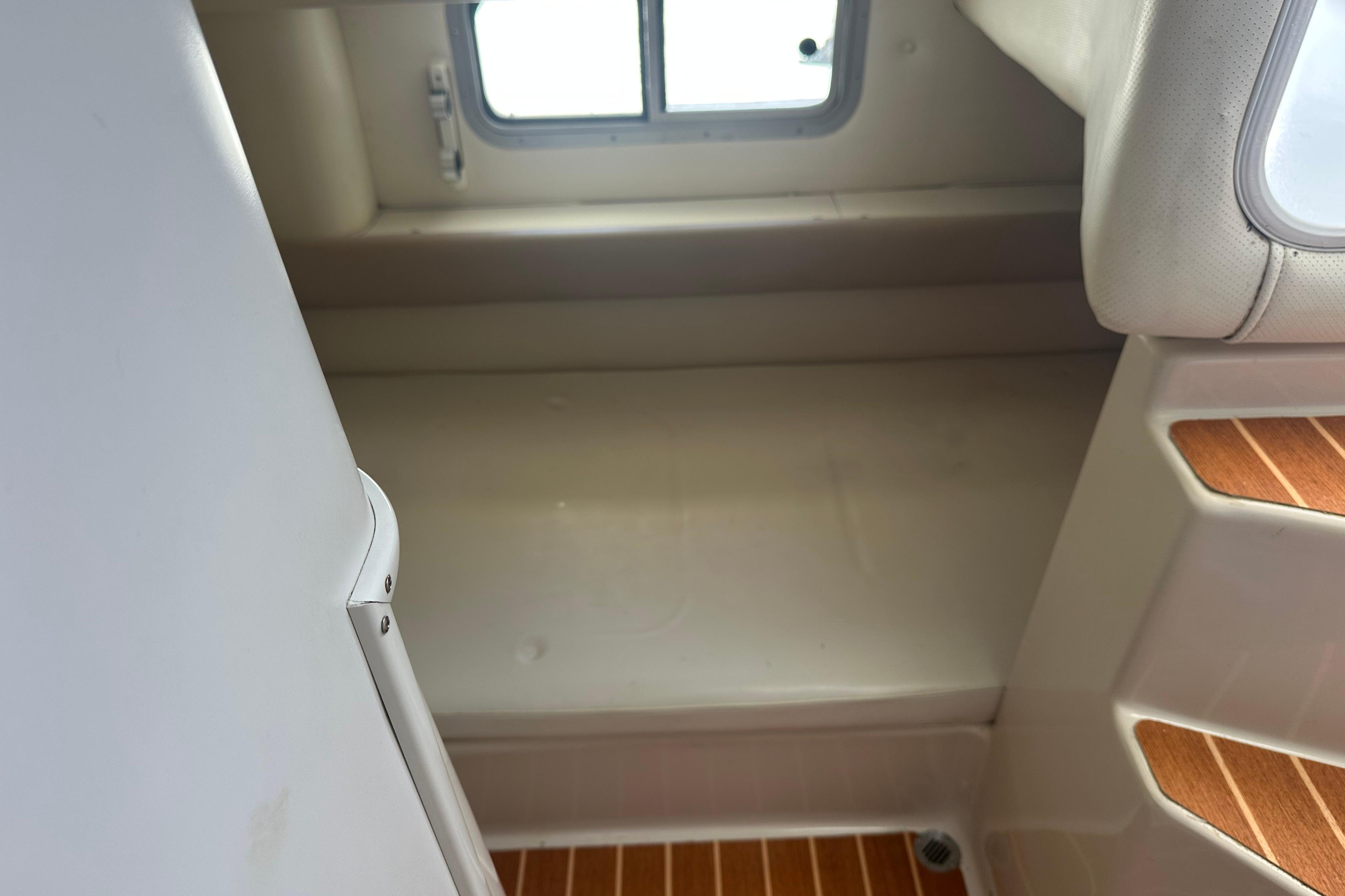 Interior cabin view of a 1994 Pro-Line 2950 Walkaround boat, featuring a compact sleeping area.