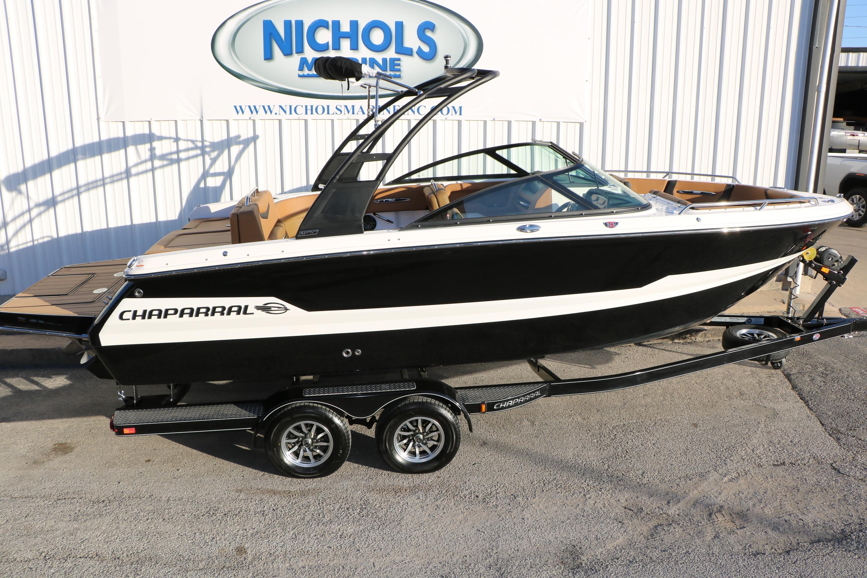 2026 Chaparral 247 SSX boat on trailer at Nichols Marine dealership.