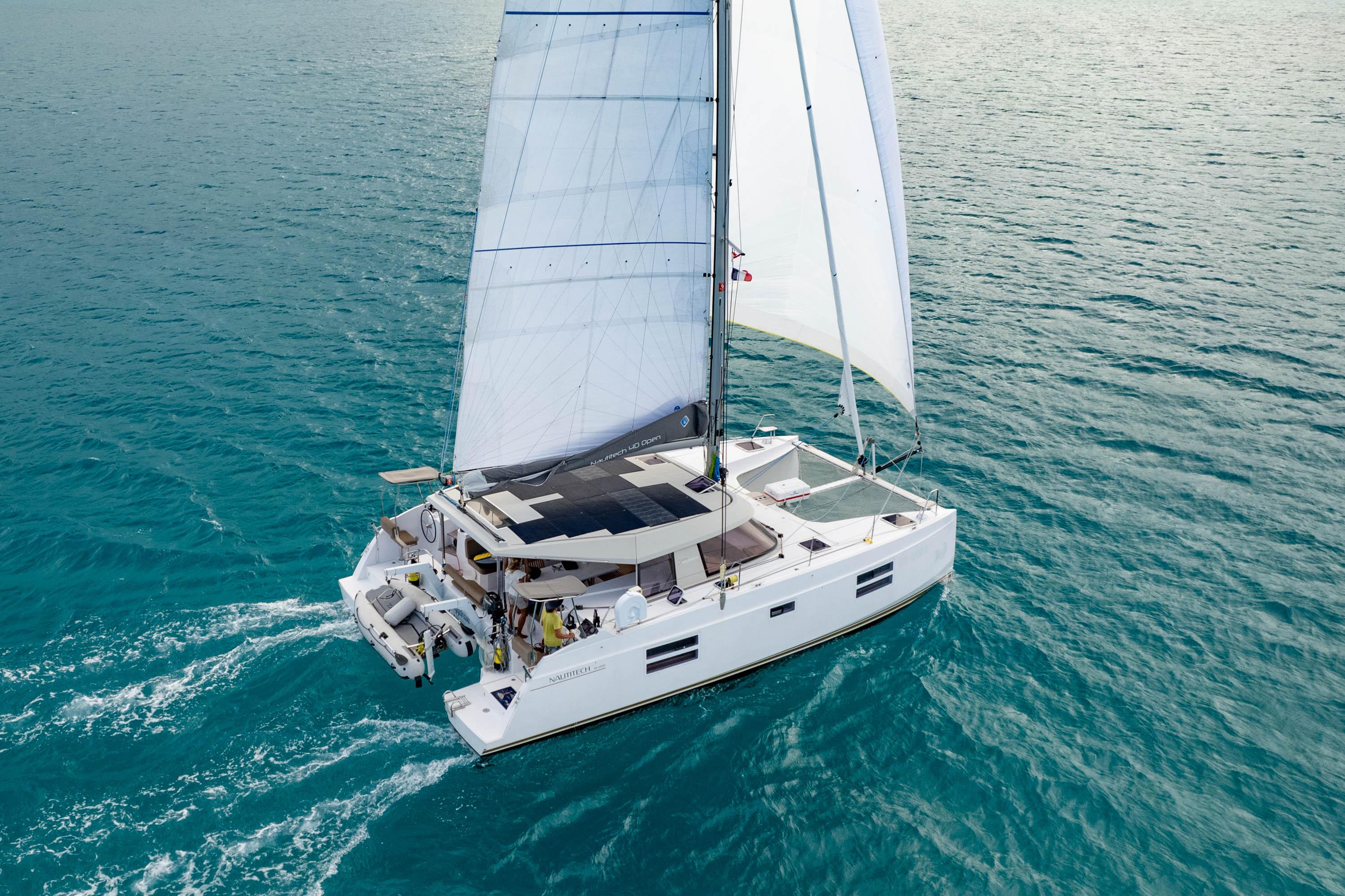 2019 Nautitech 40 Open catamaran sailing on clear blue ocean waters.