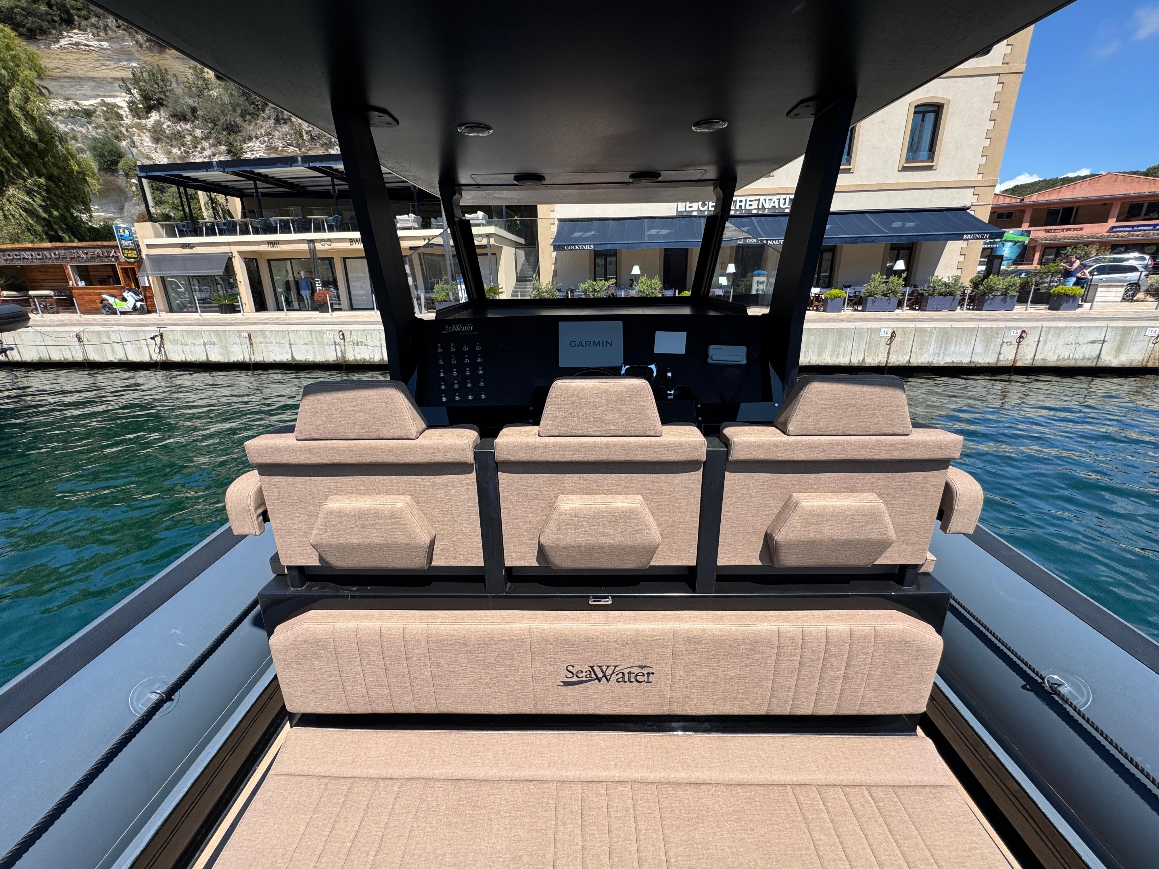 Interior view of 2021 Sea Water Phantom 400 boat with beige seating and waterfront backdrop.