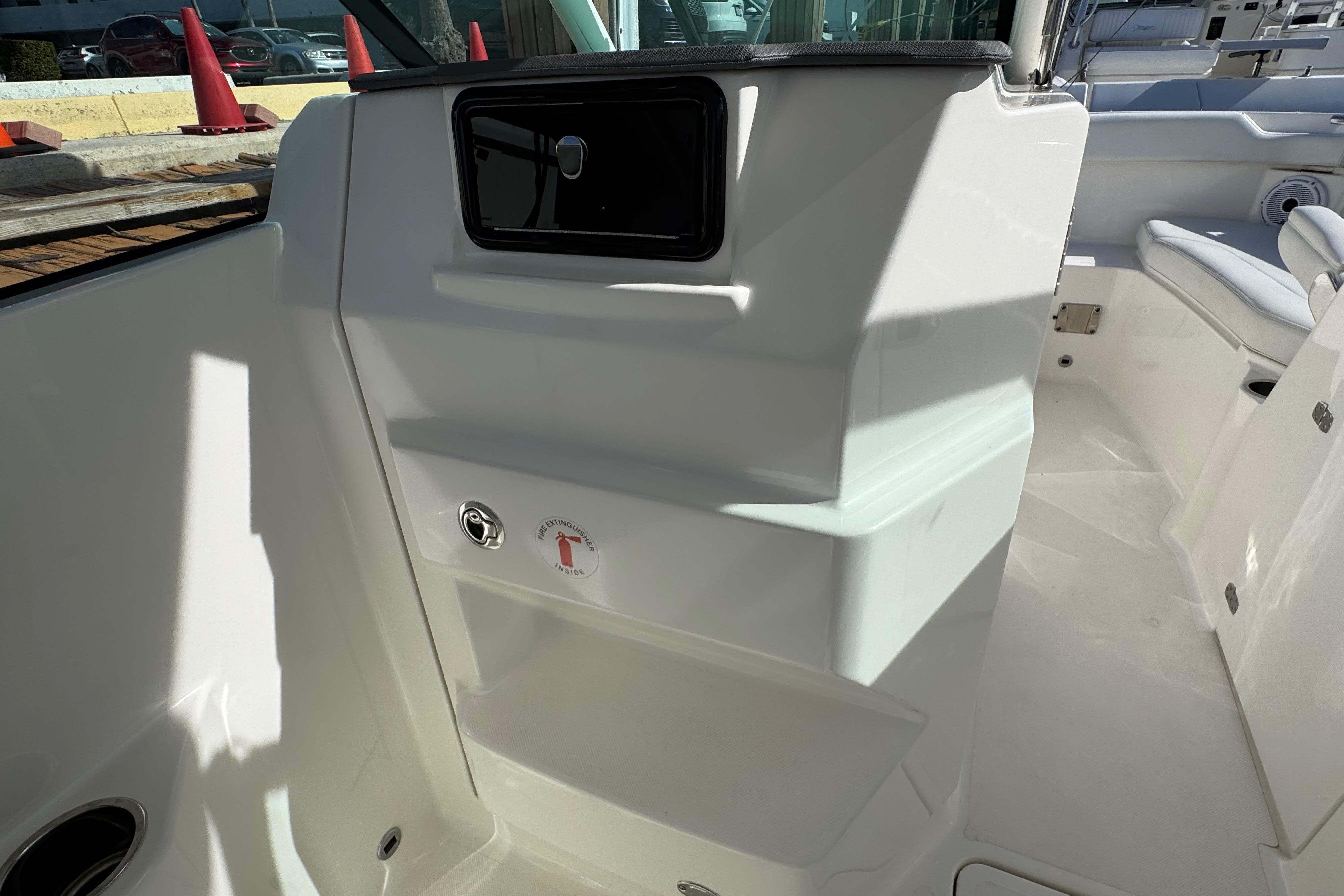 2022 Pursuit DC 266 Dual Console interior with storage compartment and seating area.