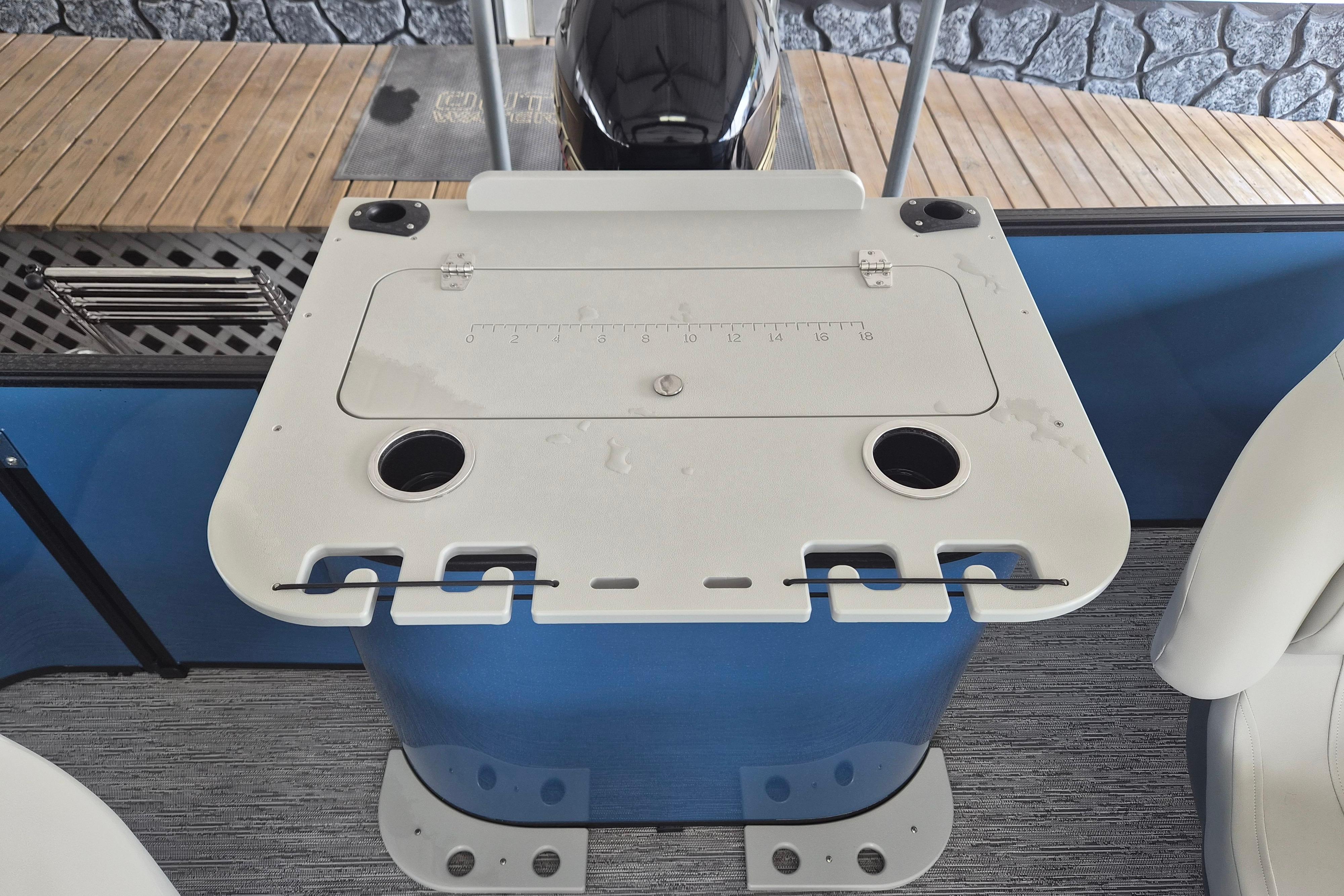 Fishing station on 2026 Sylvan Mirage Fish 820 Party Fish boat, featuring rod holders and cup holders.
