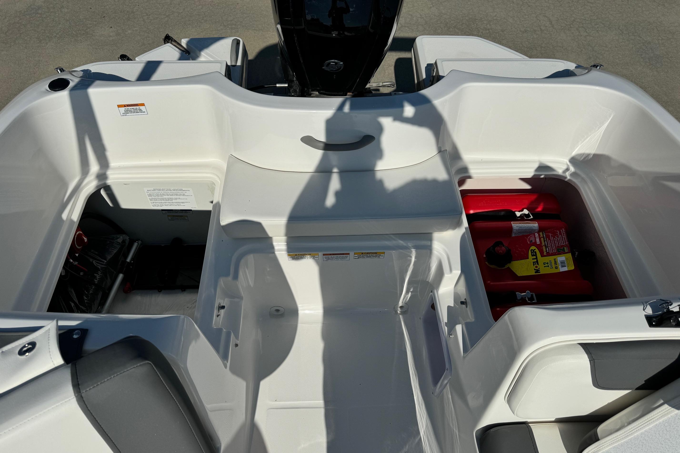 2025 Bayliner Element E16 boat interior with storage compartments and seating.