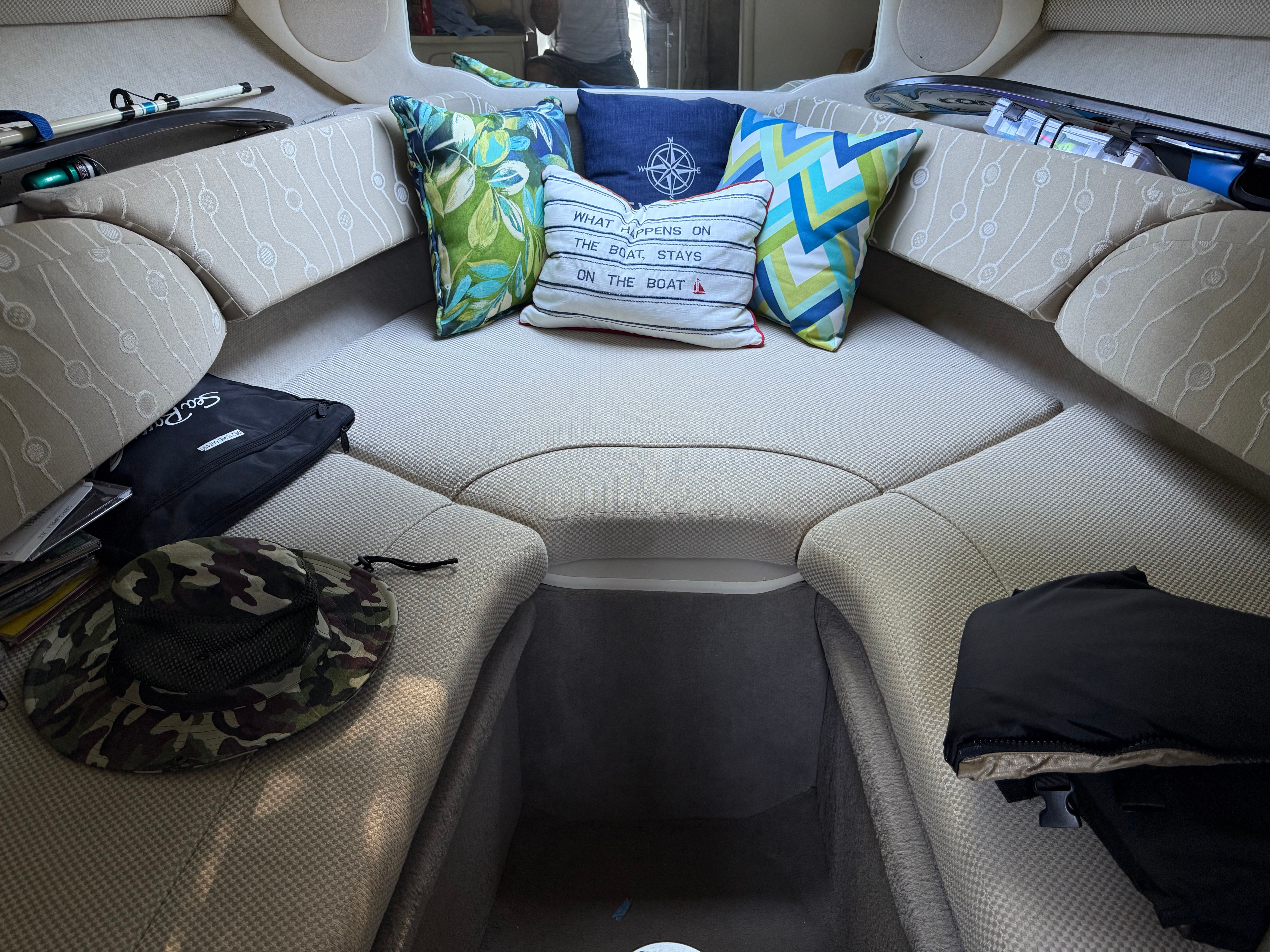 Interior of a 2006 Sea Ray 215 Weekender boat with cushions.