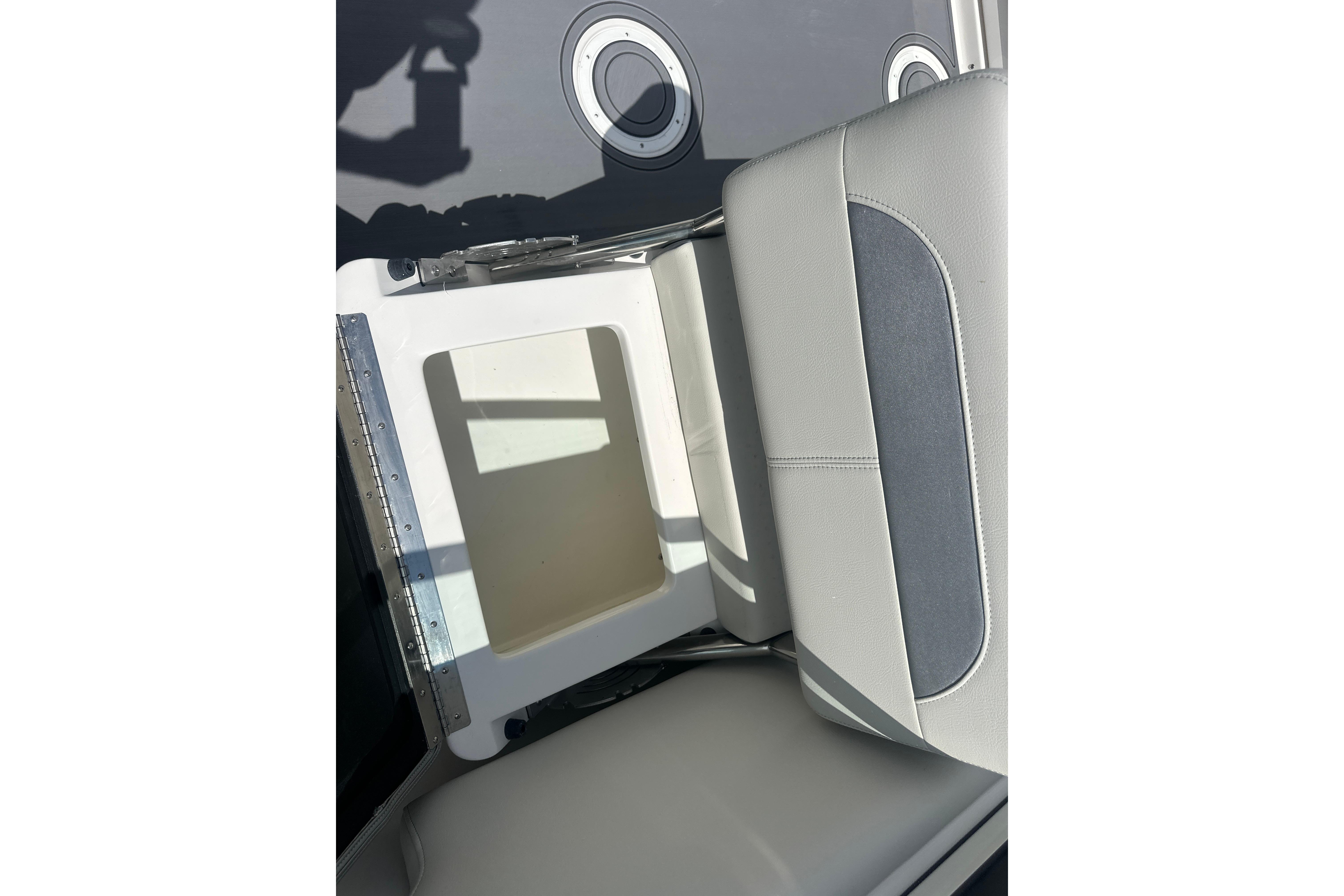 2026 Sailfish 226 DC boat seat with storage compartment, open view.