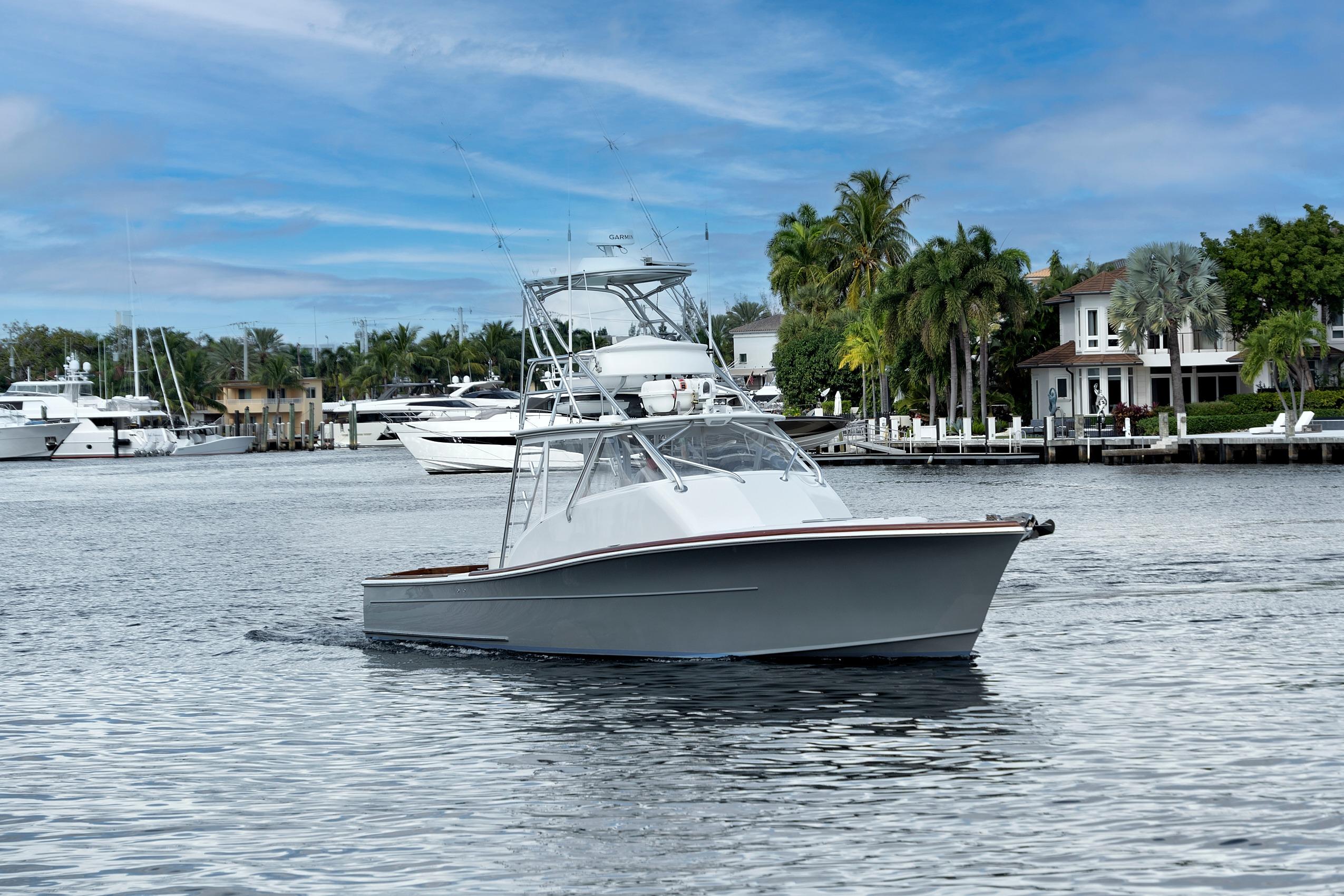 2014 Release Walkaround boat cruising in a scenic marina with palm trees and yachts.