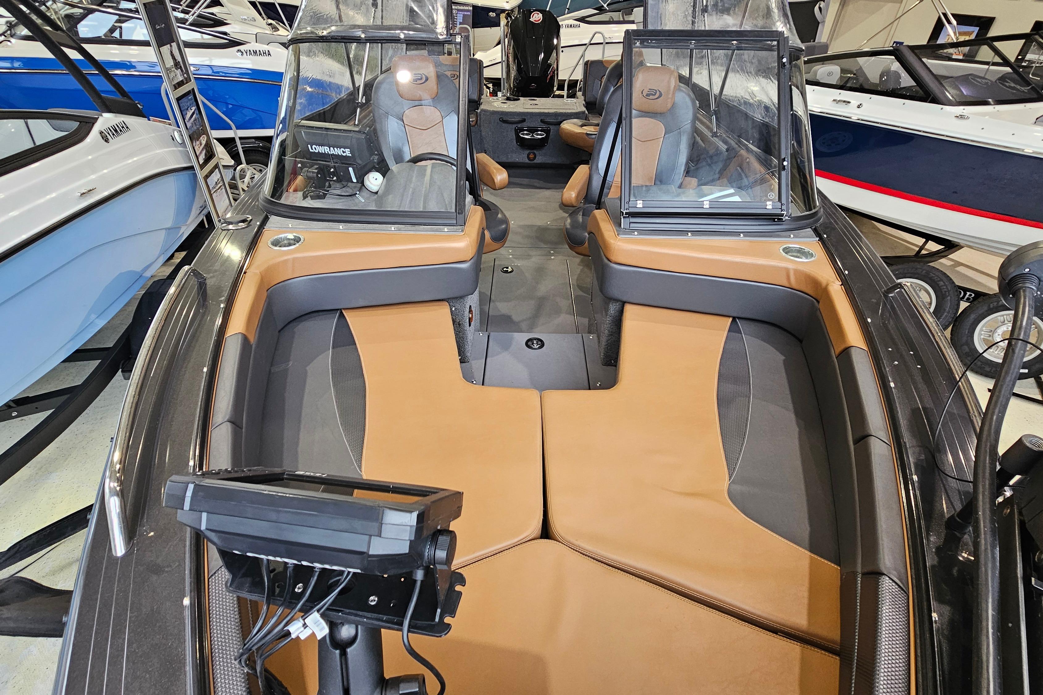 2019 Princecraft Platinum SE 227 boat interior with tan and gray seating, featuring dual consoles.